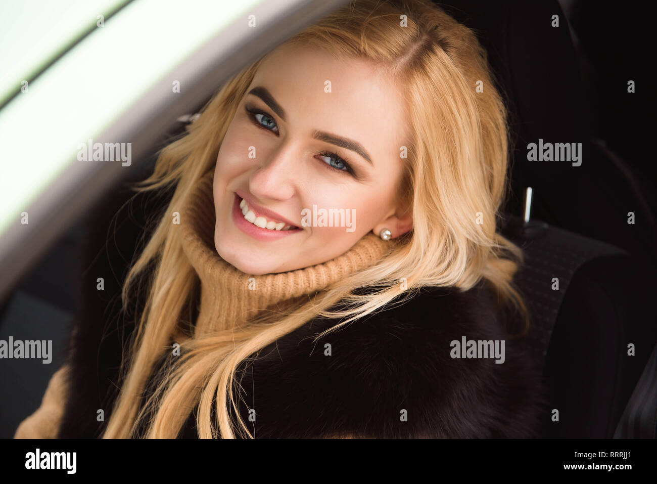 Young beautiful blonde woman driving her car Stock Photo