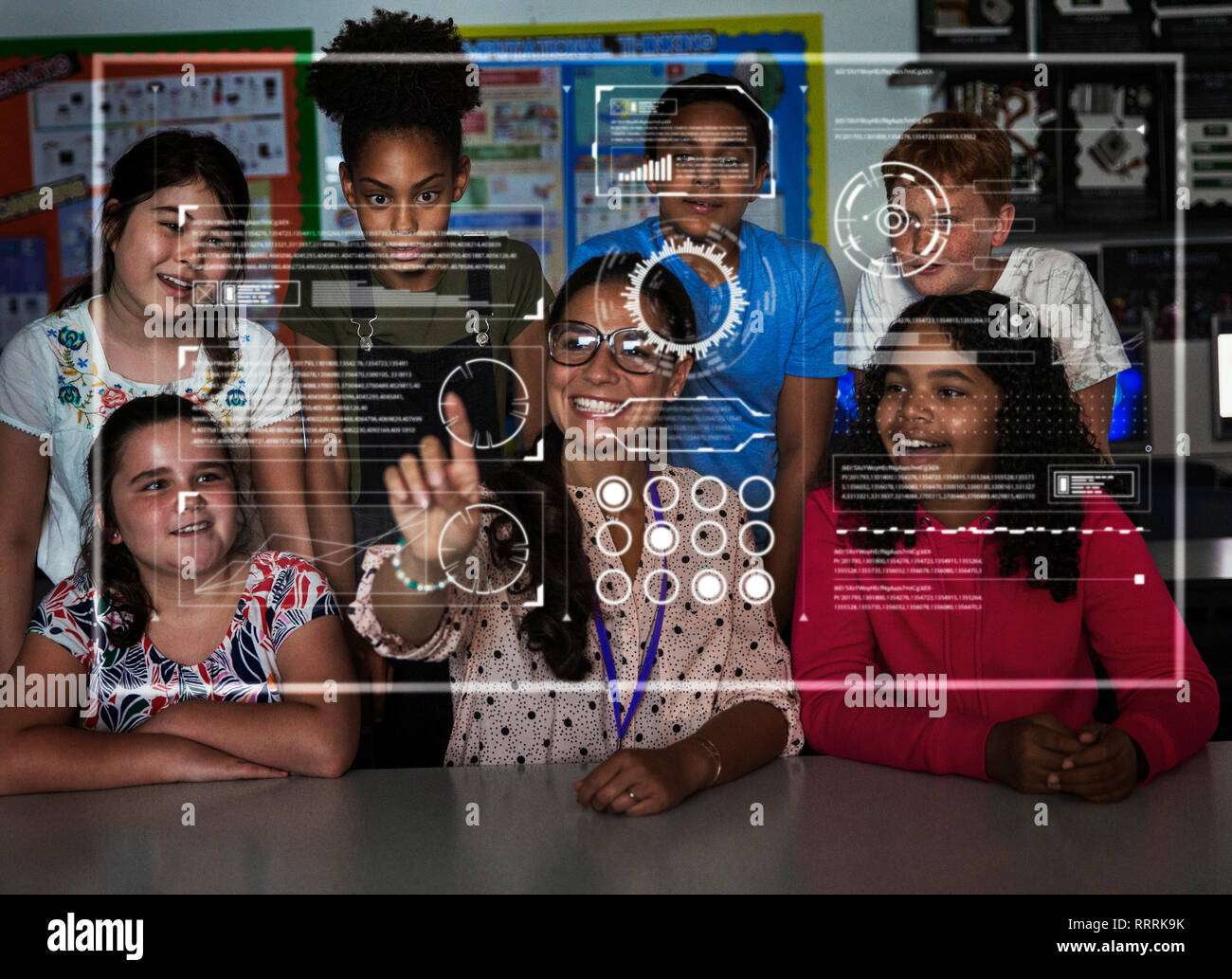 Teacher and junior high school students using futuristic touch screen in classroom Stock Photo