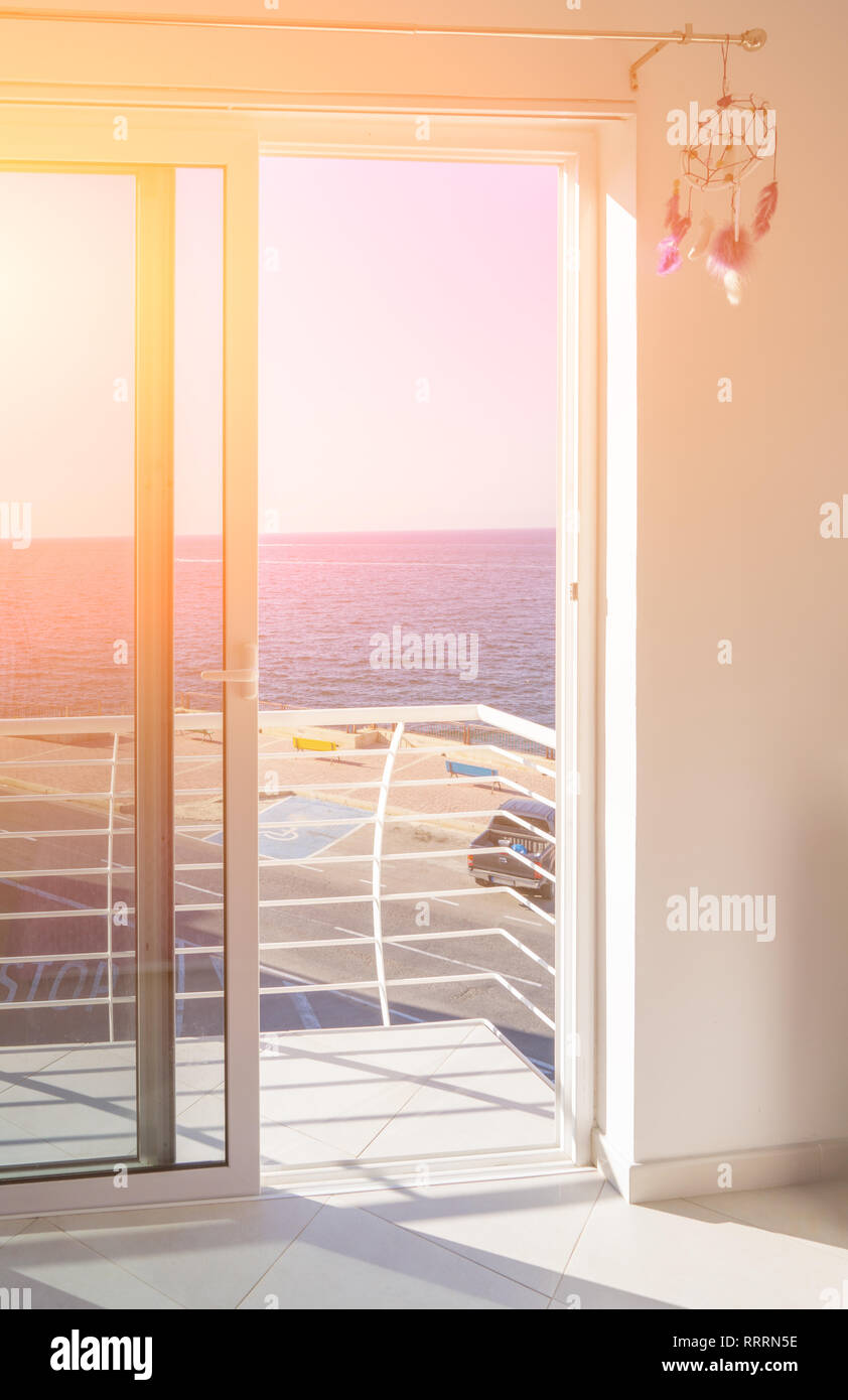 View Of Balcony With Floor To Ceiling Windows And Open Sliding