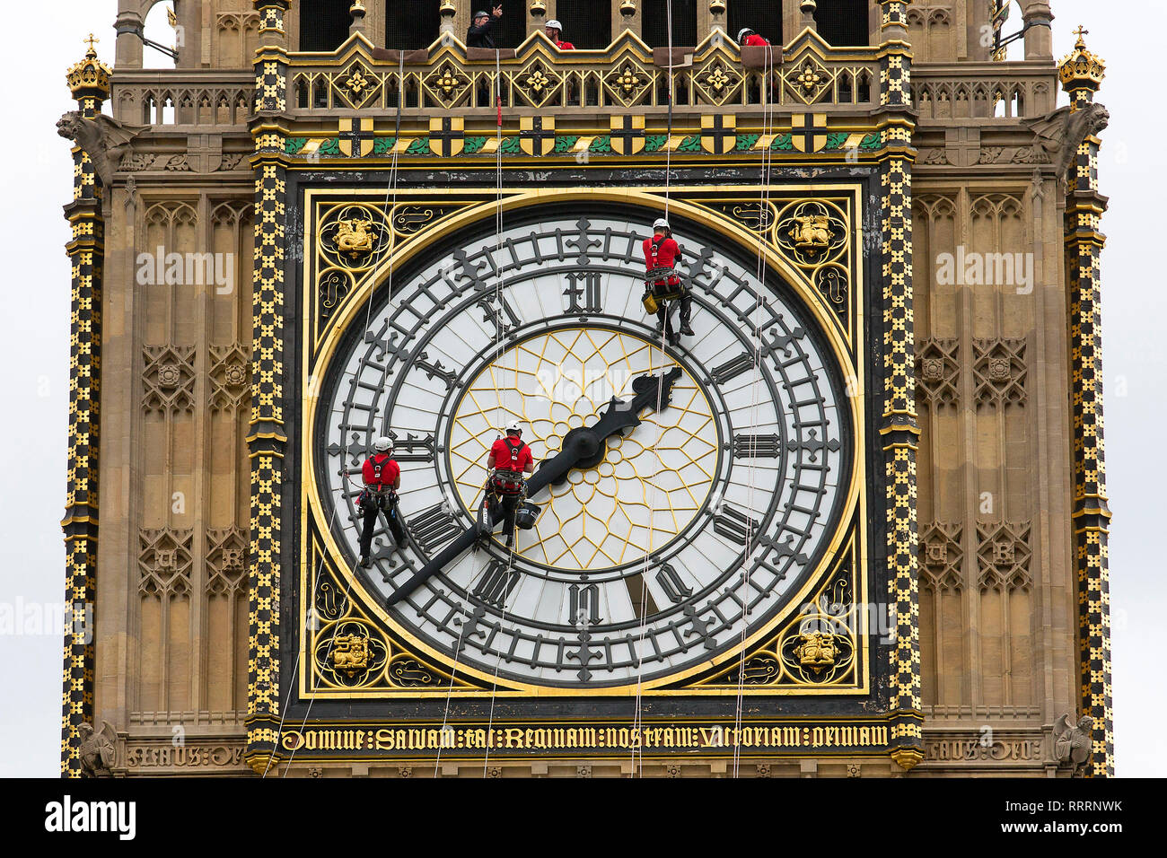Workers clean the clock face of the Elizabeth Tower (Big Ben) of the Houses of Parliament on August 21, 2014. Stock Photo