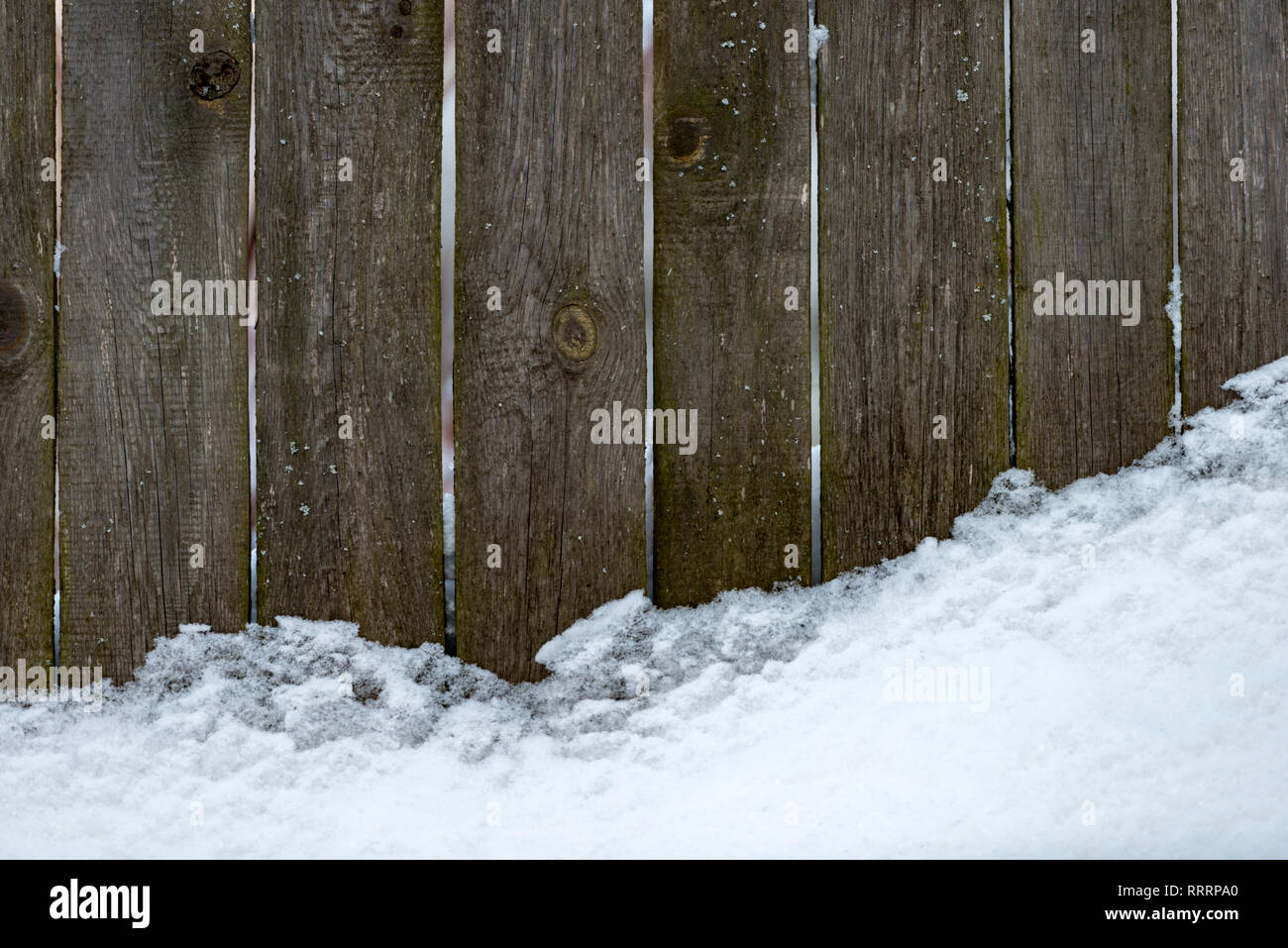 Wooden fence covered with white snow. Old plank background Stock Photo ...