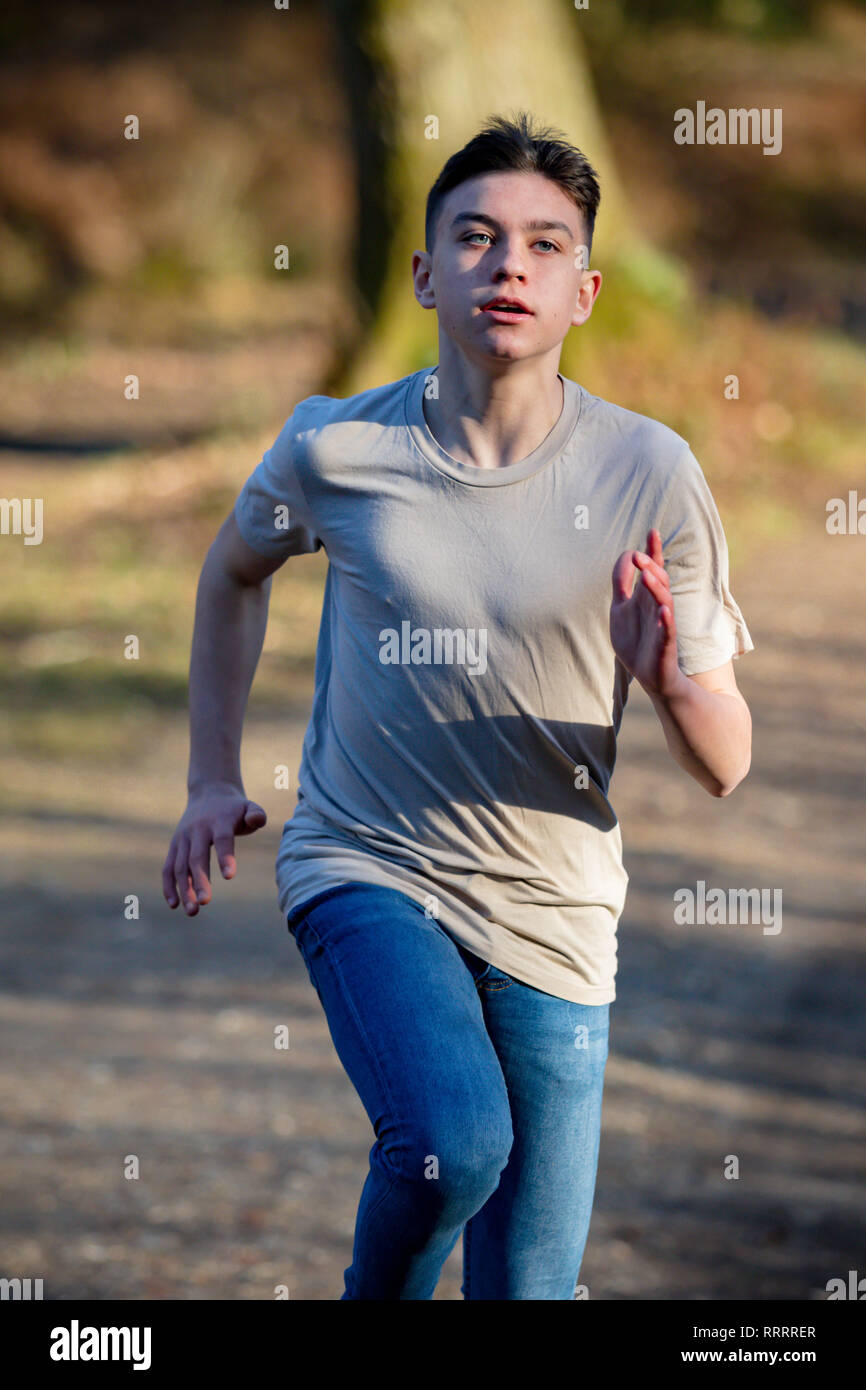 Caucasian teenage boy running on a warm spring day Stock Photo - Alamy