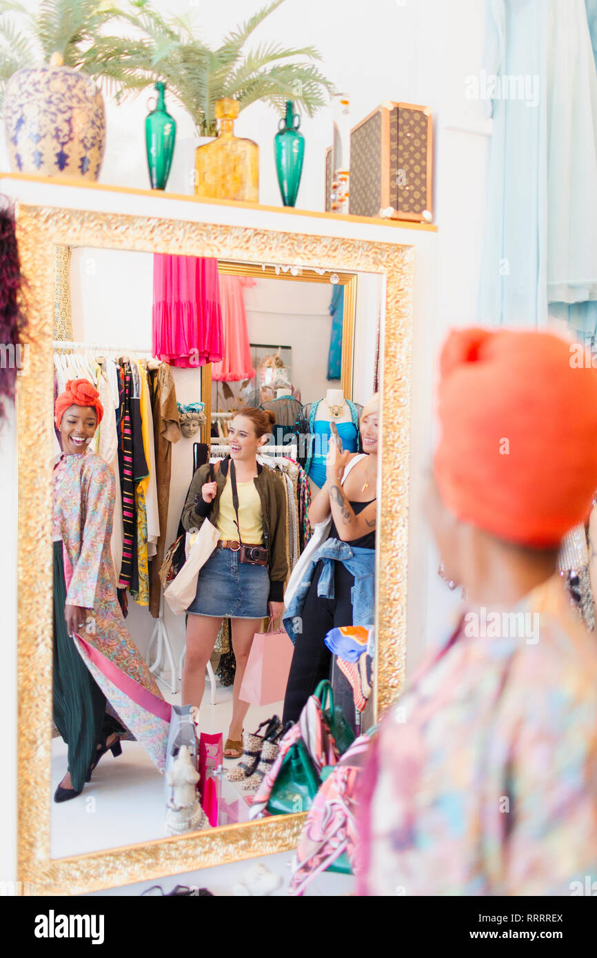 Young women friends shopping in clothing store Stock Photo