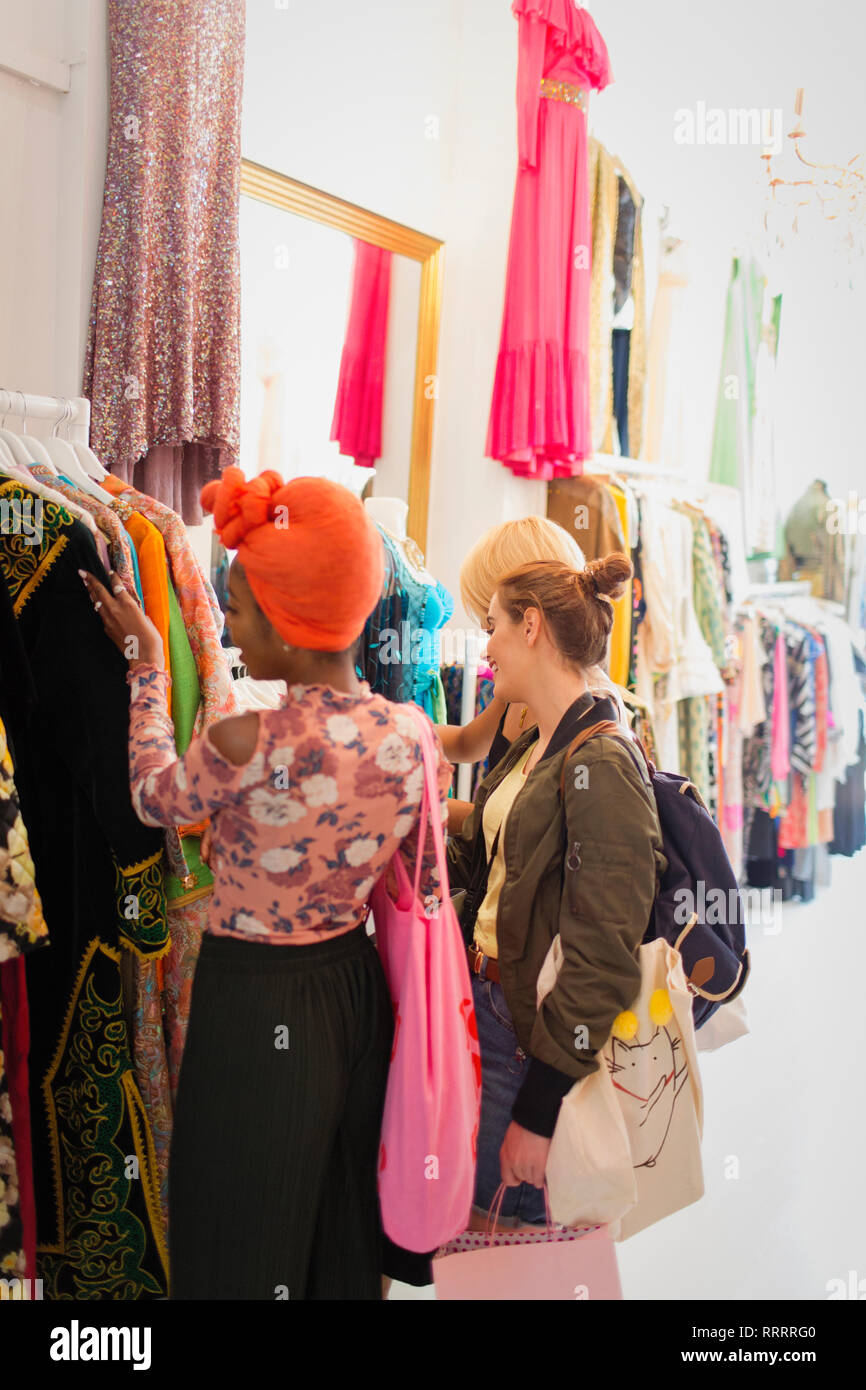 Young women friends shopping in clothing store Stock Photo