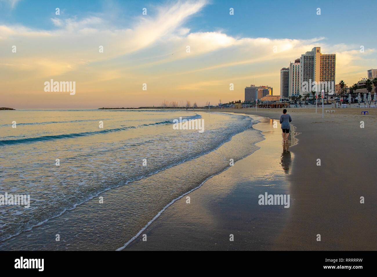 Person going for a morning jog along the Tayelet, Tel Aviv's urban beach, Tel Aviv, Israel Stock Photo
