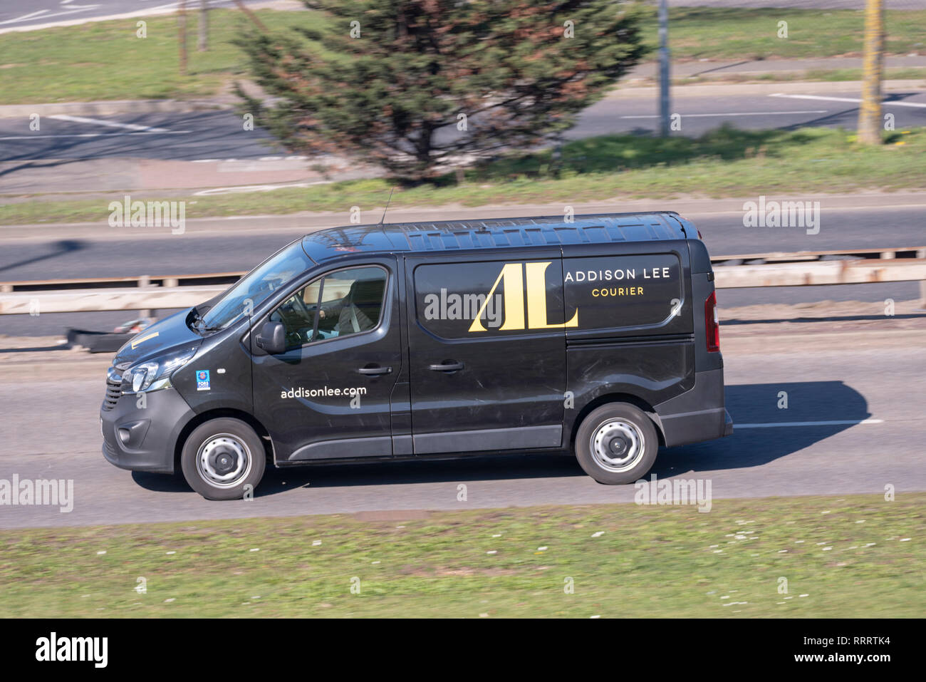 Addison Lee couriers delivery van driving on the road. Mail courier transport business Stock Photo