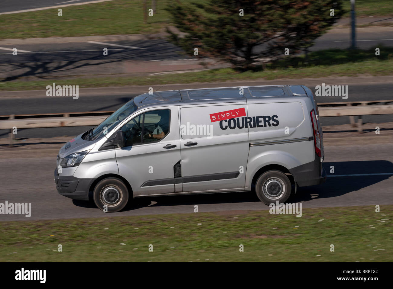 Simply Couriers courier delivery van driving on the road Stock Photo
