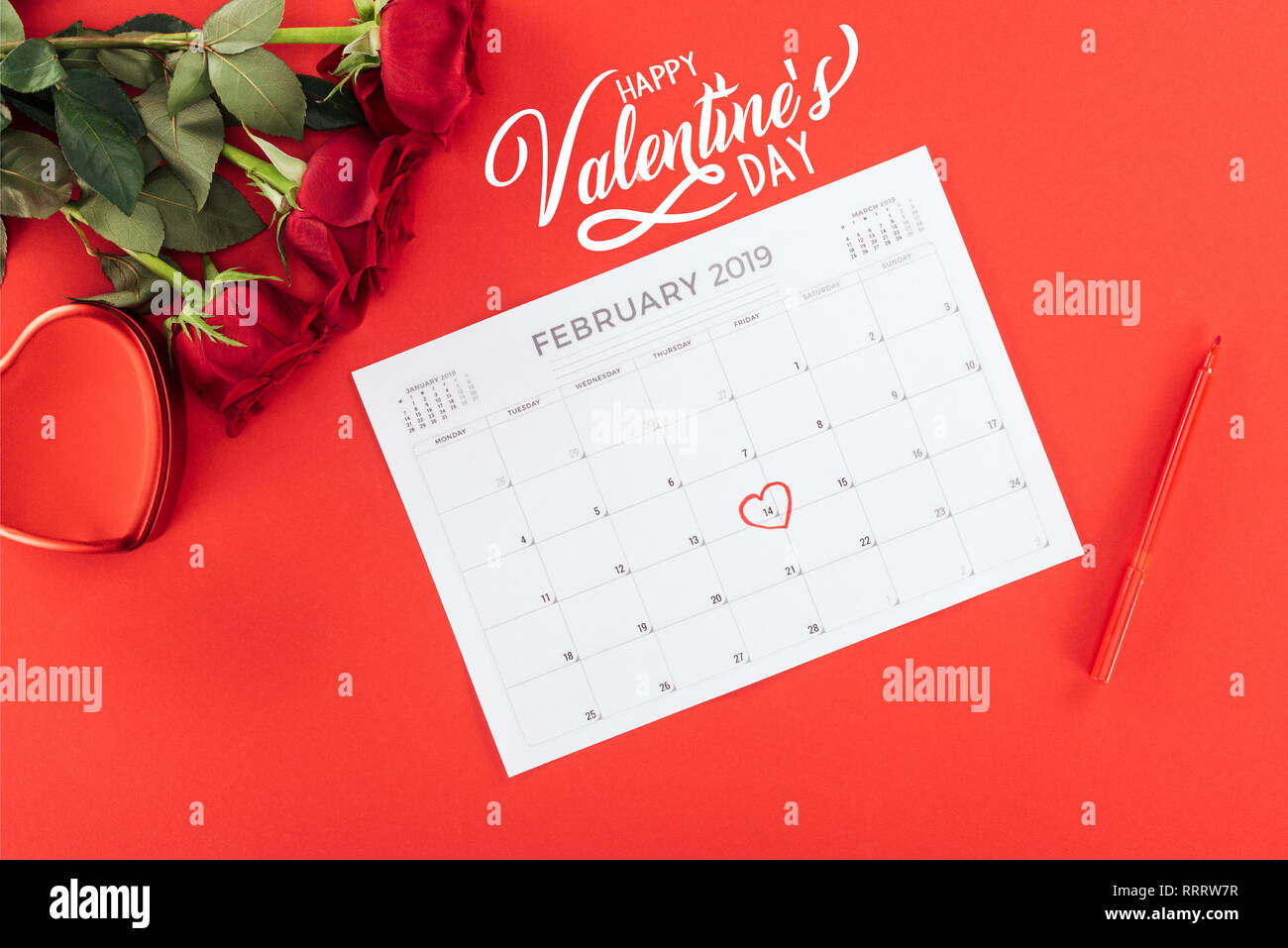 Top View Of Roses And Calendar With 14th February Date Top View Of Roses And Calendar With 14th February Date