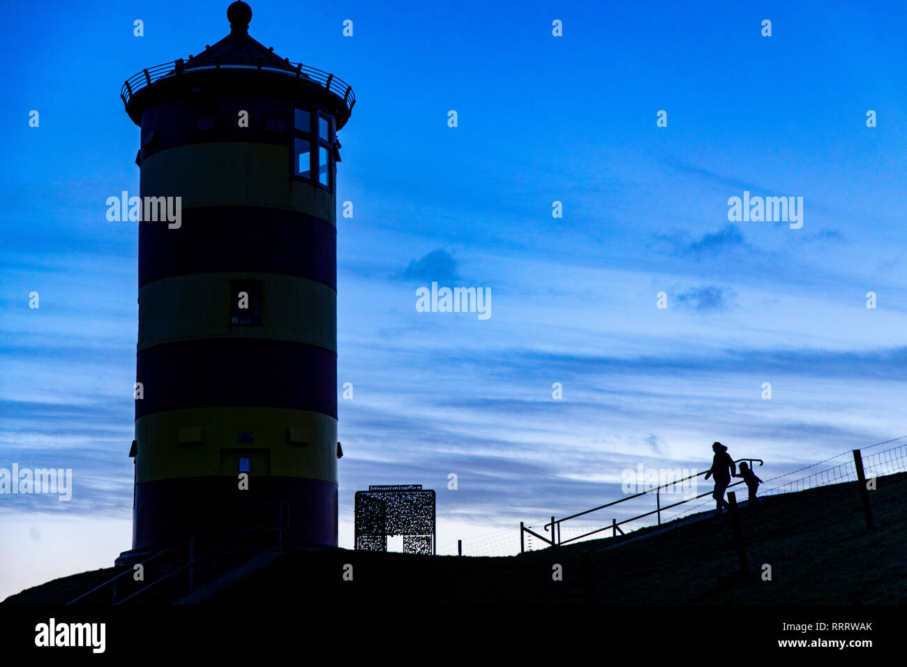 The Pilsum lighthouse on the North Sea dike near Pilsum, Krummhšrn, Ostfriesland, East Frisia, Lower Saxony, Germany Stock Photo