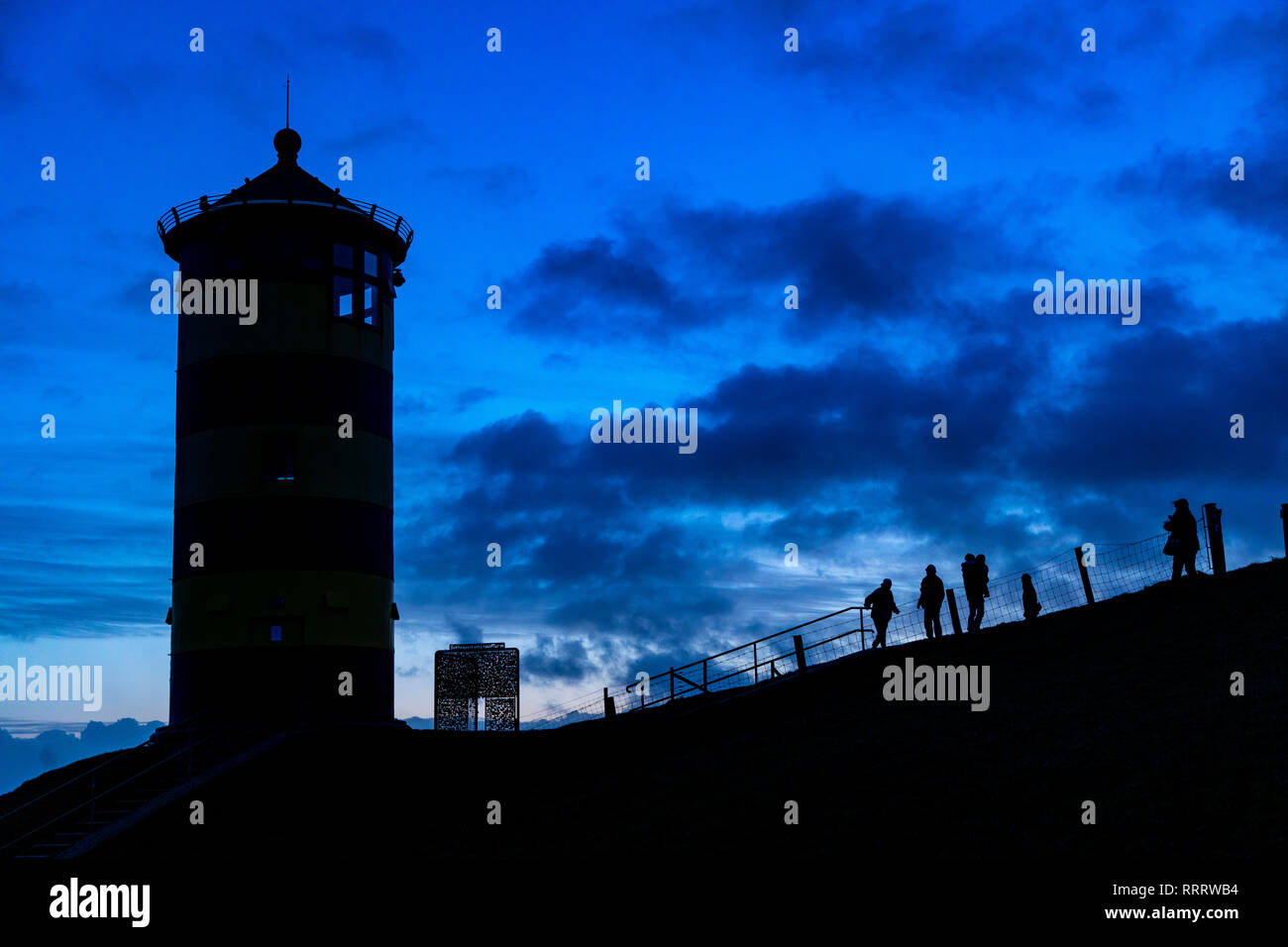 The Pilsum lighthouse on the North Sea dike near Pilsum, Krummhšrn, Ostfriesland, East Frisia, Lower Saxony, Germany Stock Photo