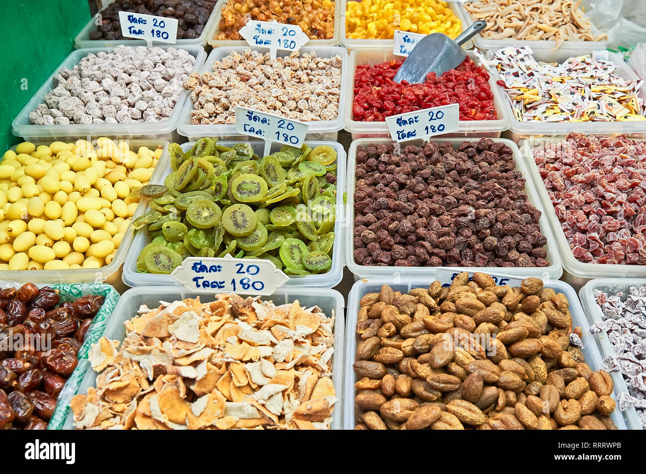 Closeup of dried fruits, presented in containers with price signage