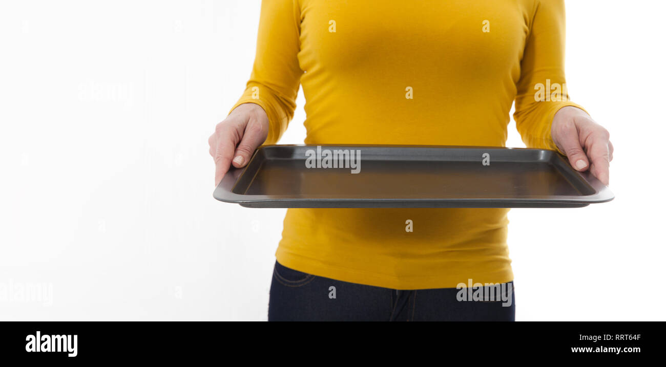 Kitchen woman waitress gives empty tray for your advertising products isolated on white background. Mock up for use Stock Photo
