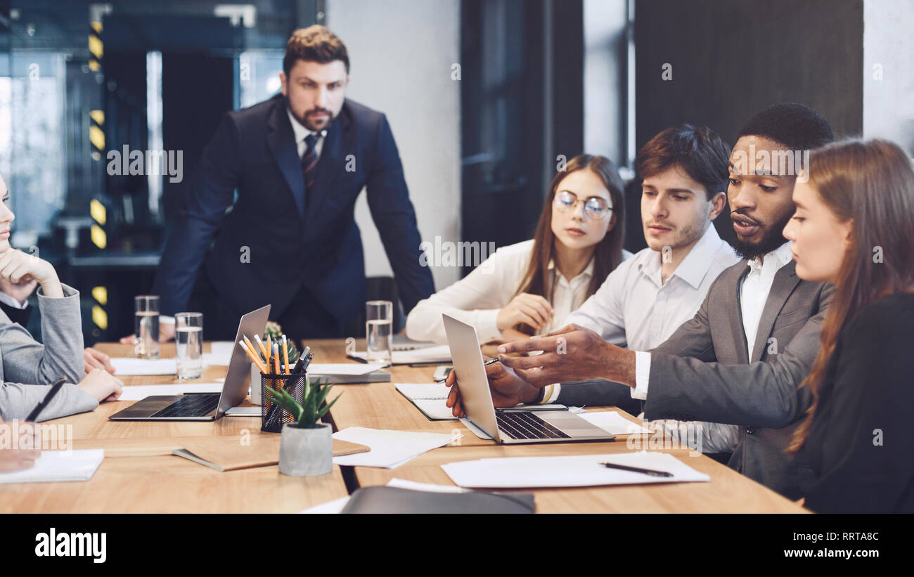 Business team using laptop, check results of their work Stock Photo