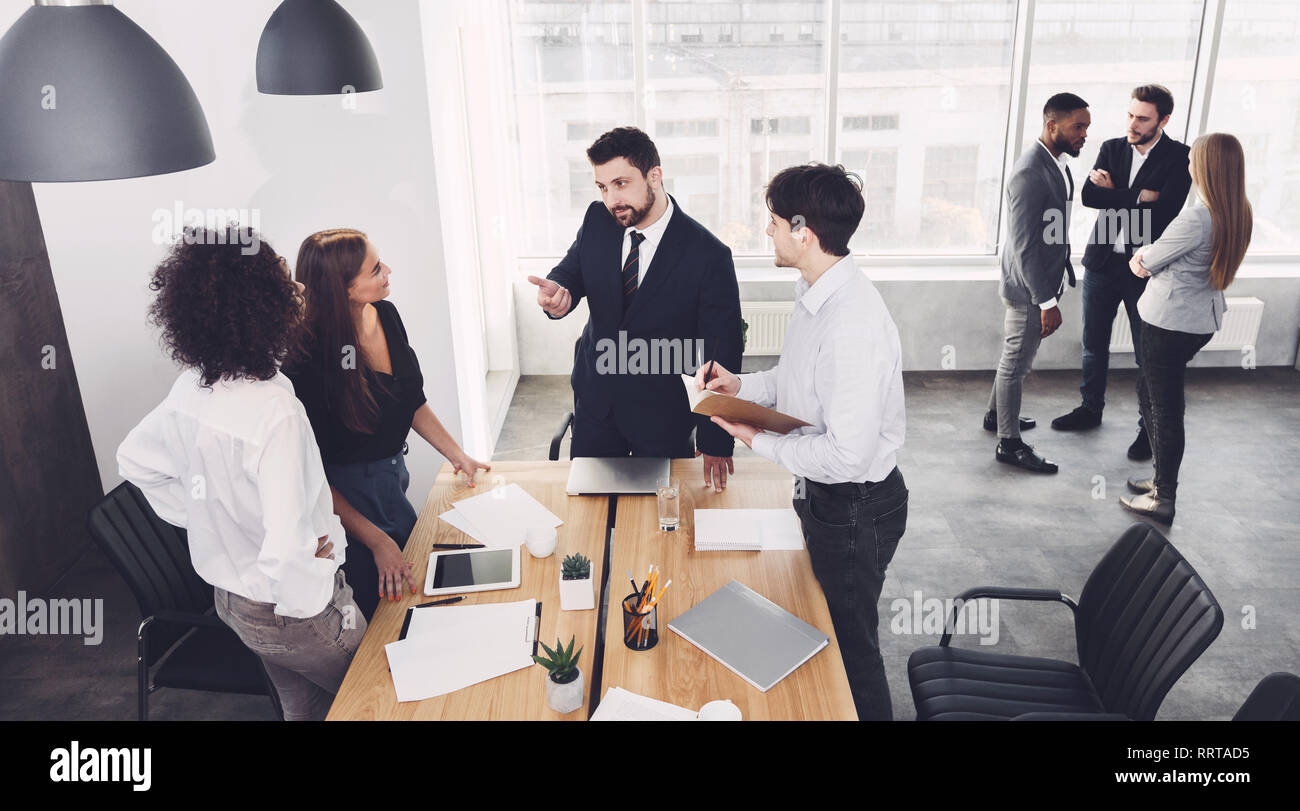 Groups of young business people communicating in office Stock Photo