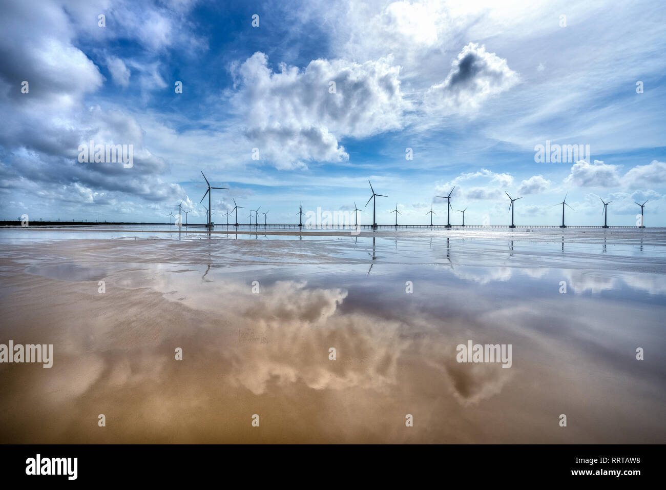 Seacape with Turbine Green Energy Electricity, Windmill for electric power production on the sea at  Bac Lieu, Vietnam. Aerial view Stock Photo