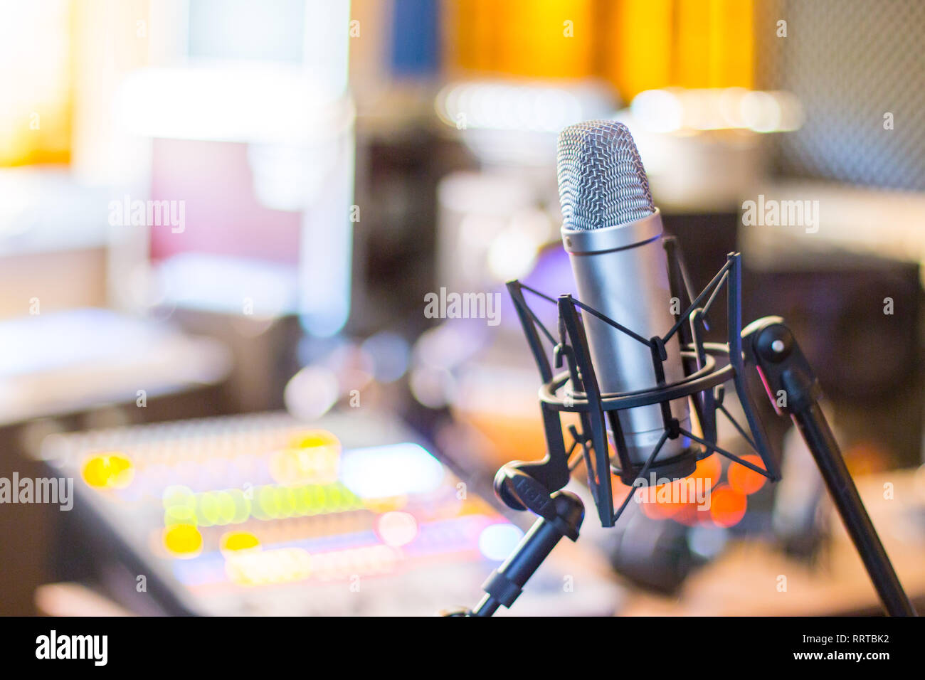 Microphone in a professional recording or radio studio, equipment in the  blurry background Stock Photo - Alamy