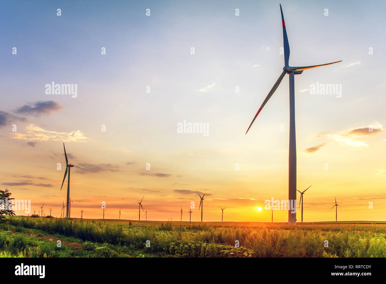 Renewable energy with wind turbines in the sunset Stock Photo - Alamy