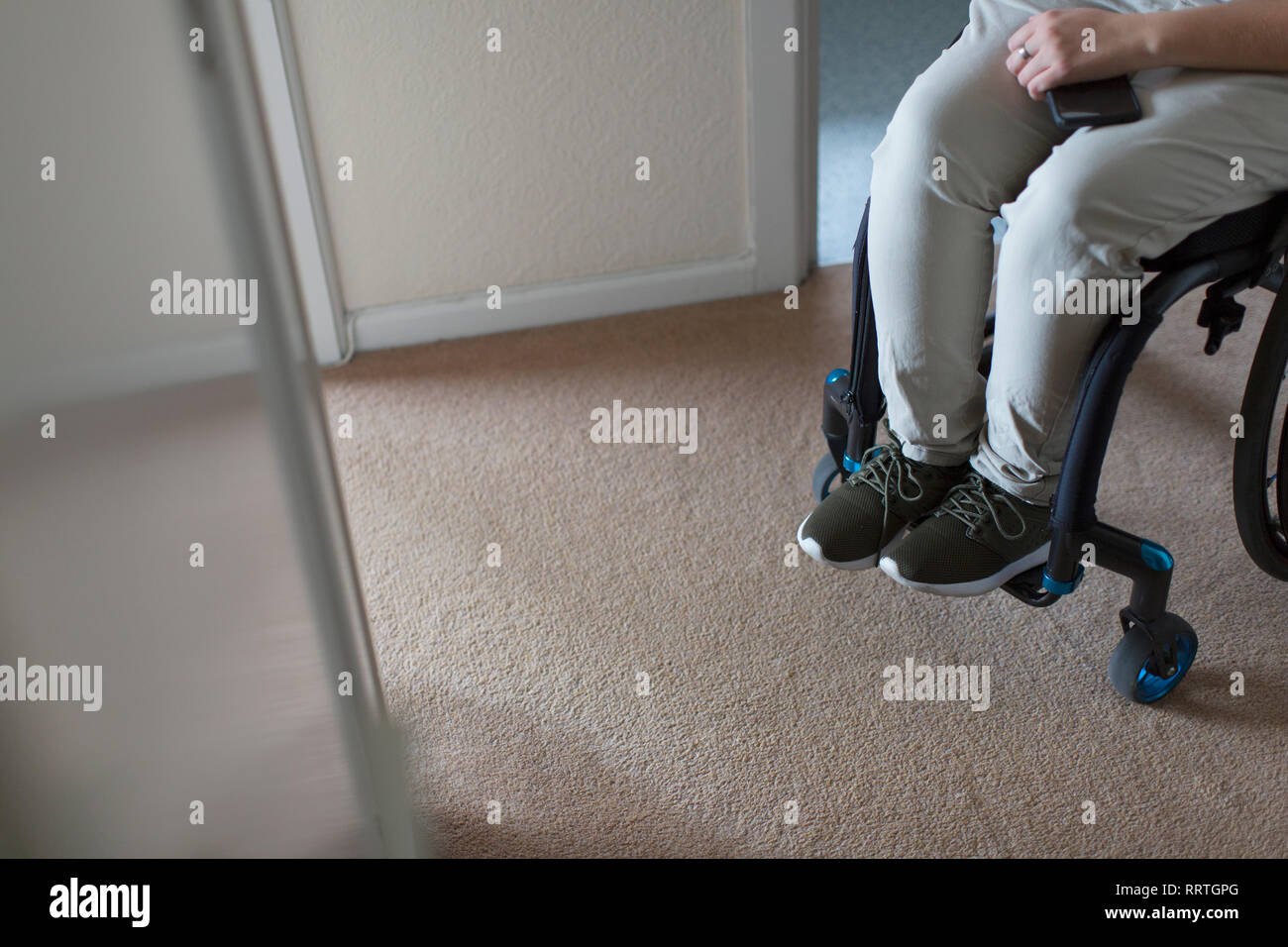 Young woman in wheelchair at home Stock Photo