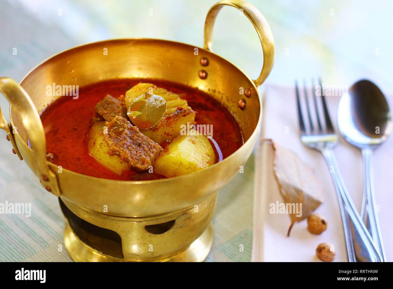 massamun curry served in beautiful brass wok set. Stock Photo