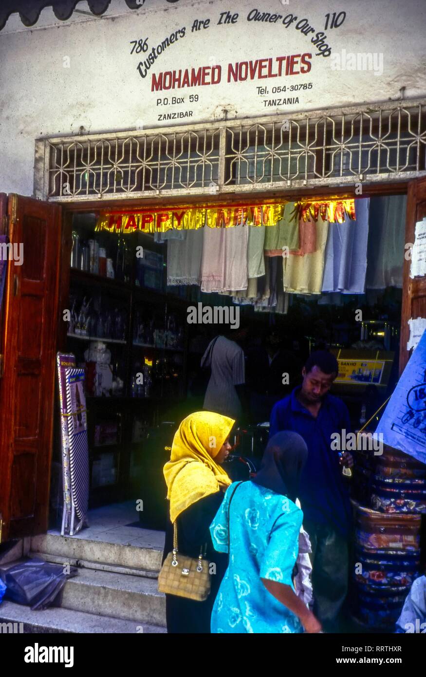 Daily life in Stone Town. Local women shopping at a store, Zanzibar, Tanzania Stock Photo