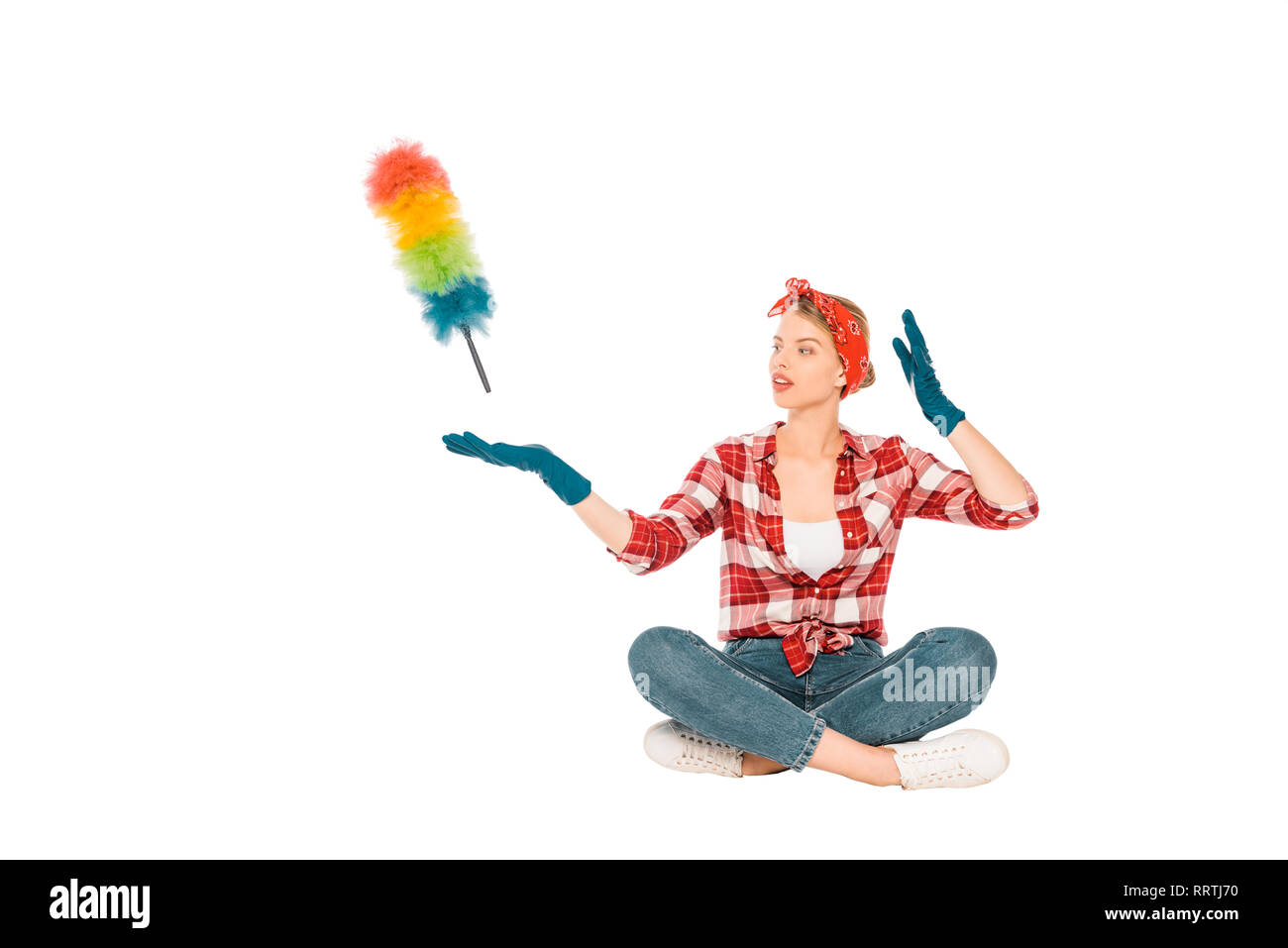 floating girl in jeans and plaid shirt with duster isolated on white Stock Photo