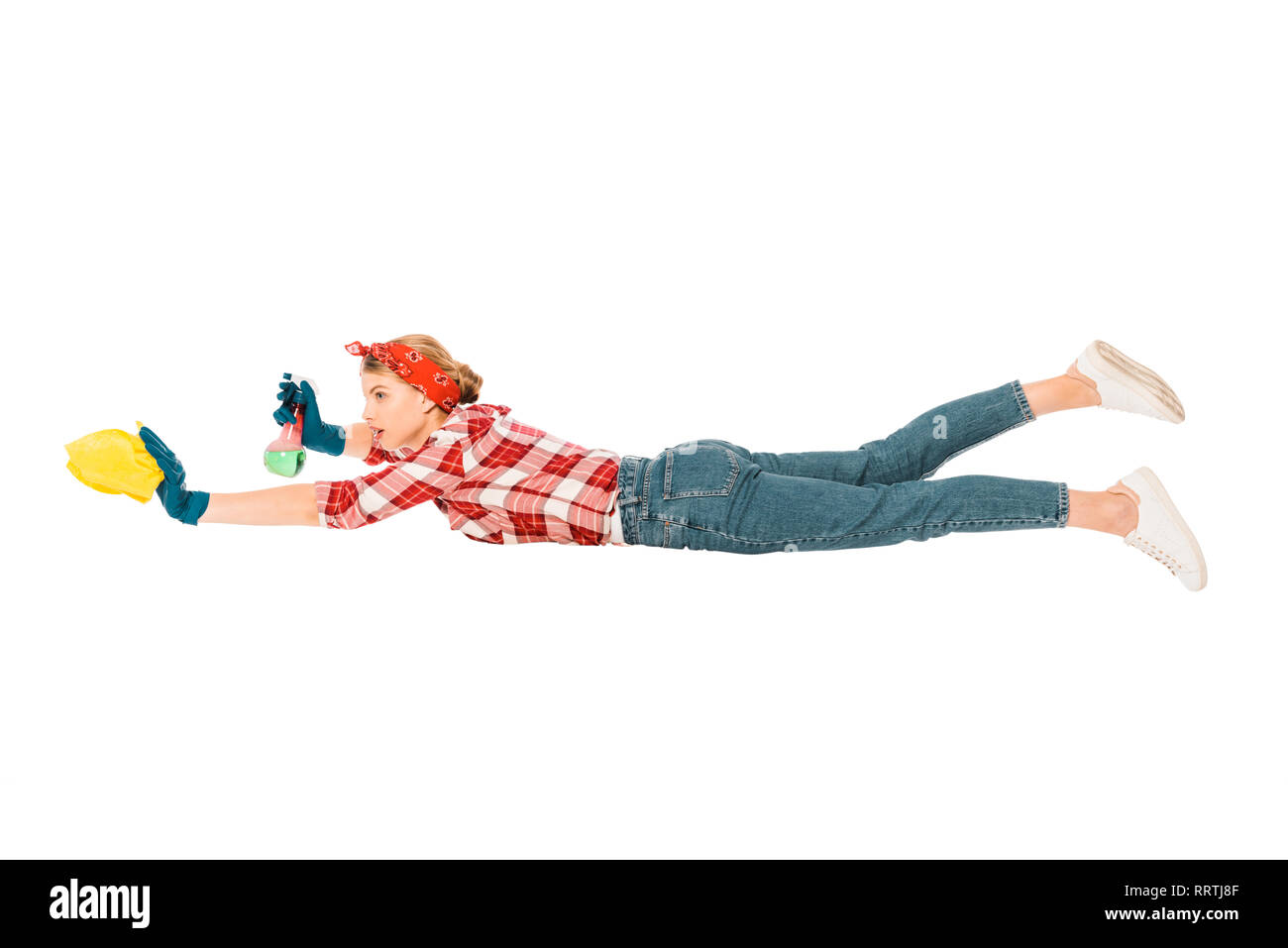 floating girl in jeans and plaid shirt cleaning with rag and spray Stock Photo