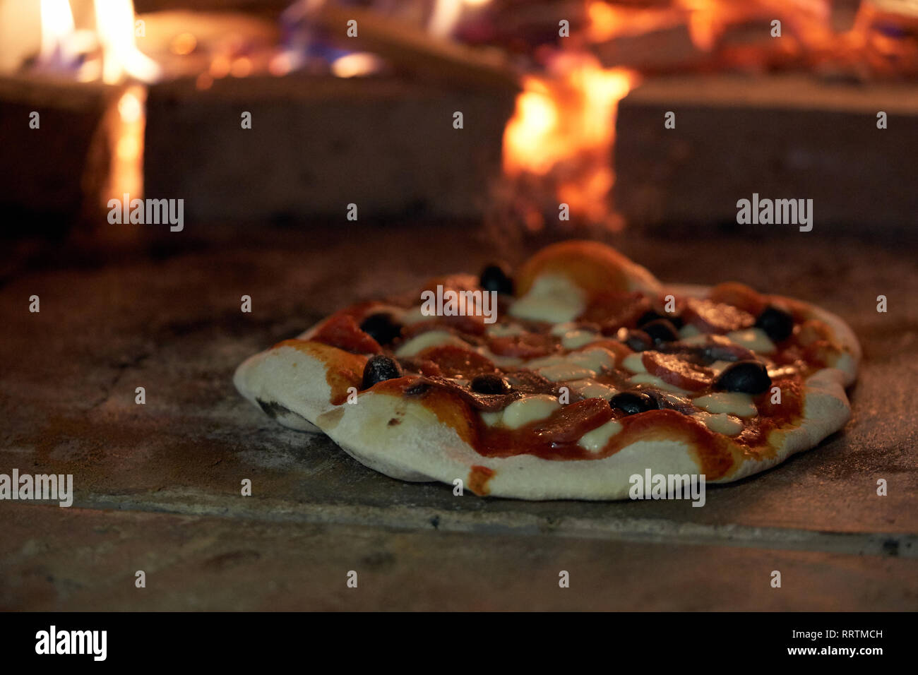 cooking pizza in a  typical oven Stock Photo