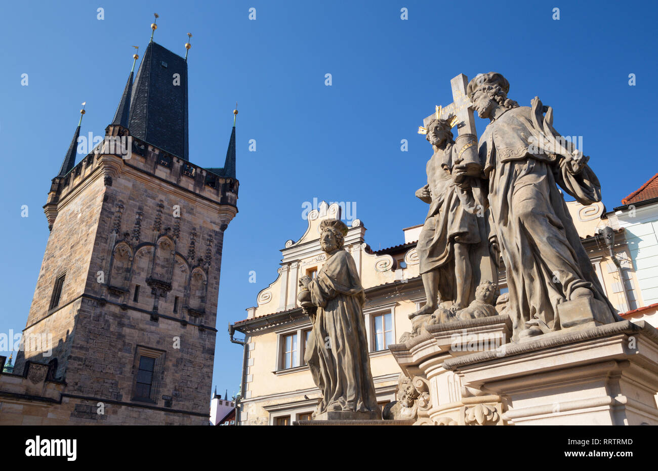 Prague - The baroque staue of st. Cosmos and st. Damian and Christ from Charles bridge by Jan Oldřich Mayer (1666 – 1721). Stock Photo