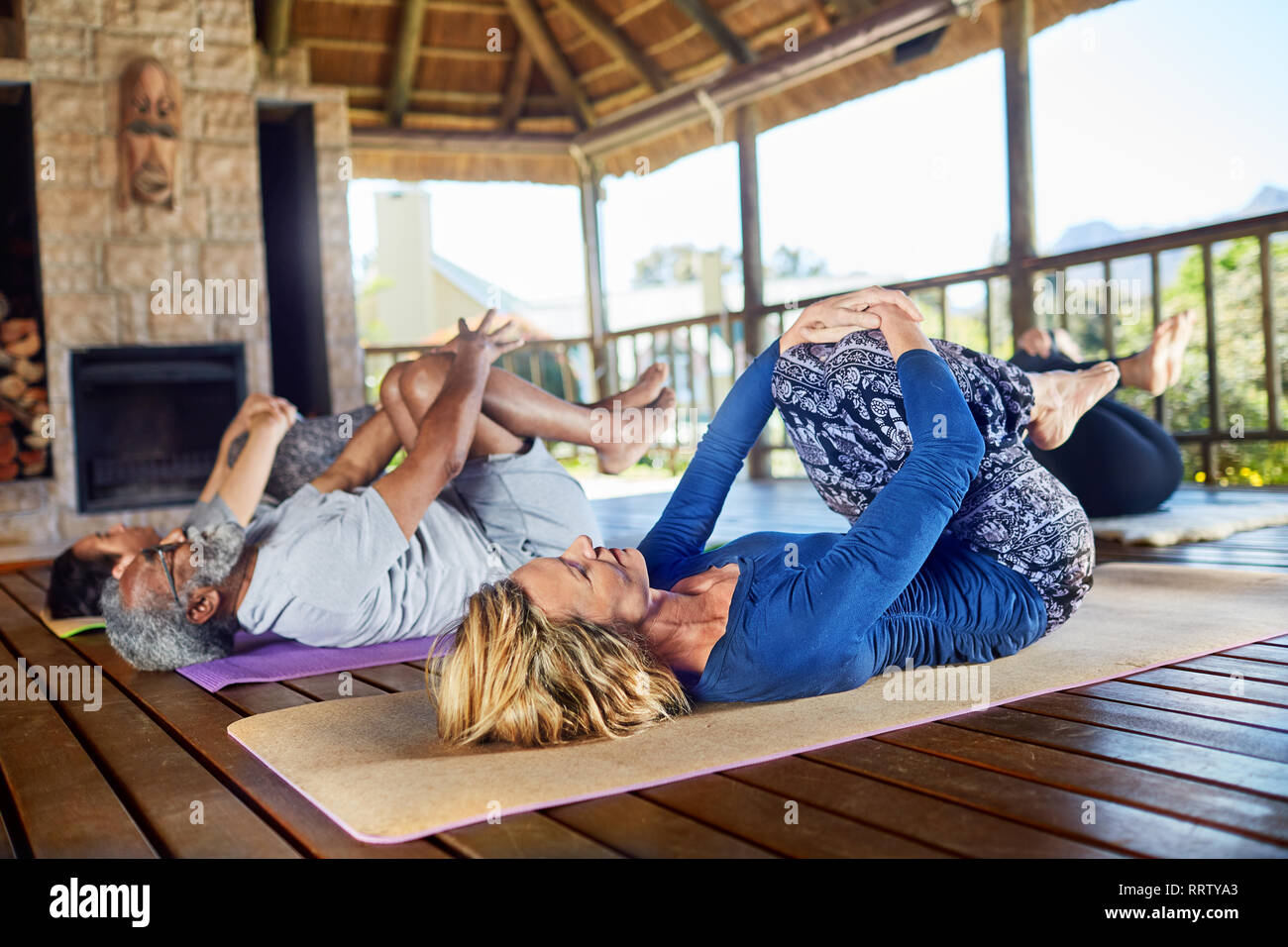 Yoga class stretching in hut during yoga retreat Stock Photo
