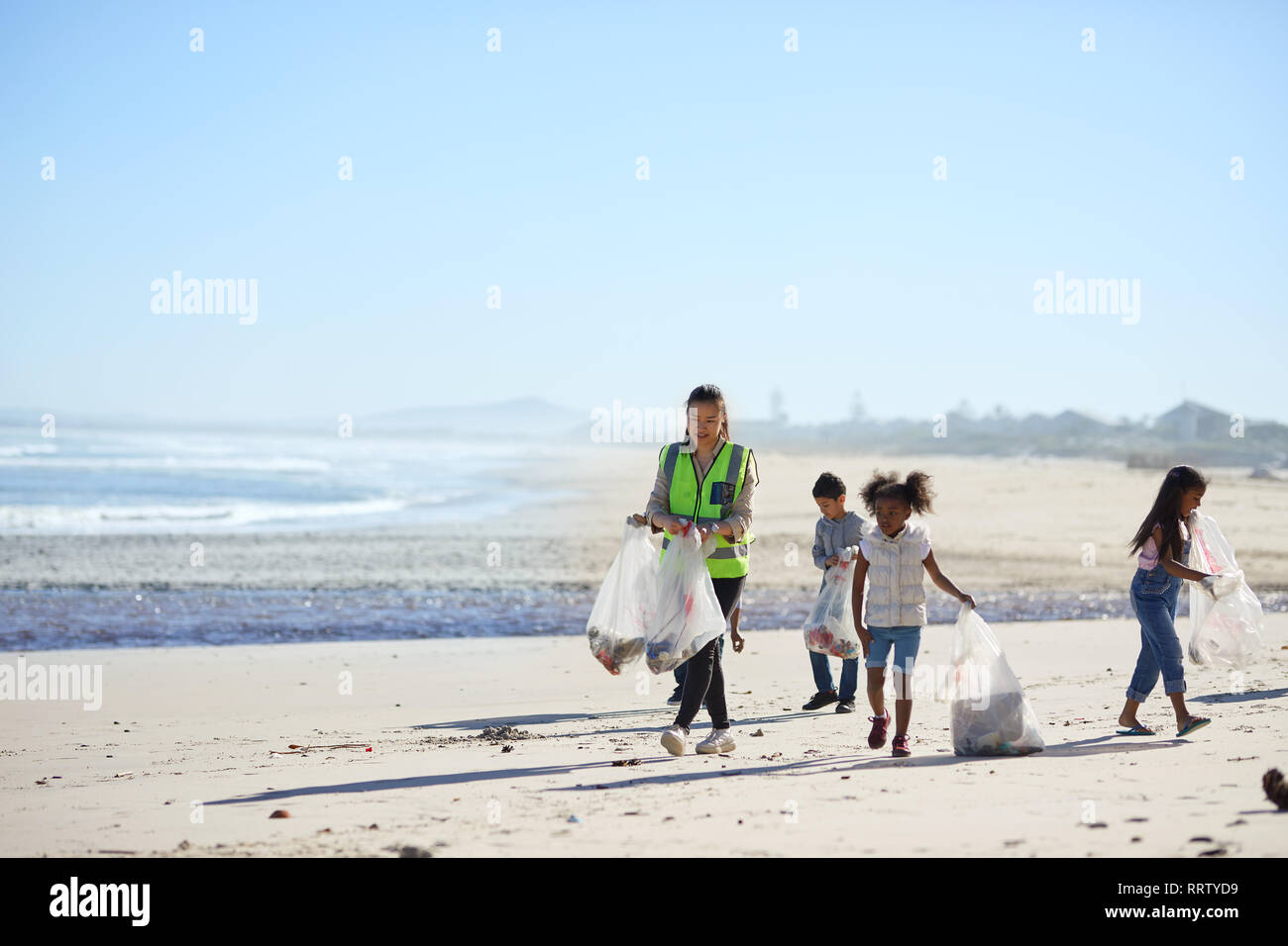Children volunteers cleaning up beach litter Stock Photo
