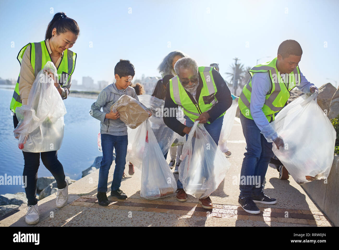 Volunteers cleaning up waterfront litter Stock Photo