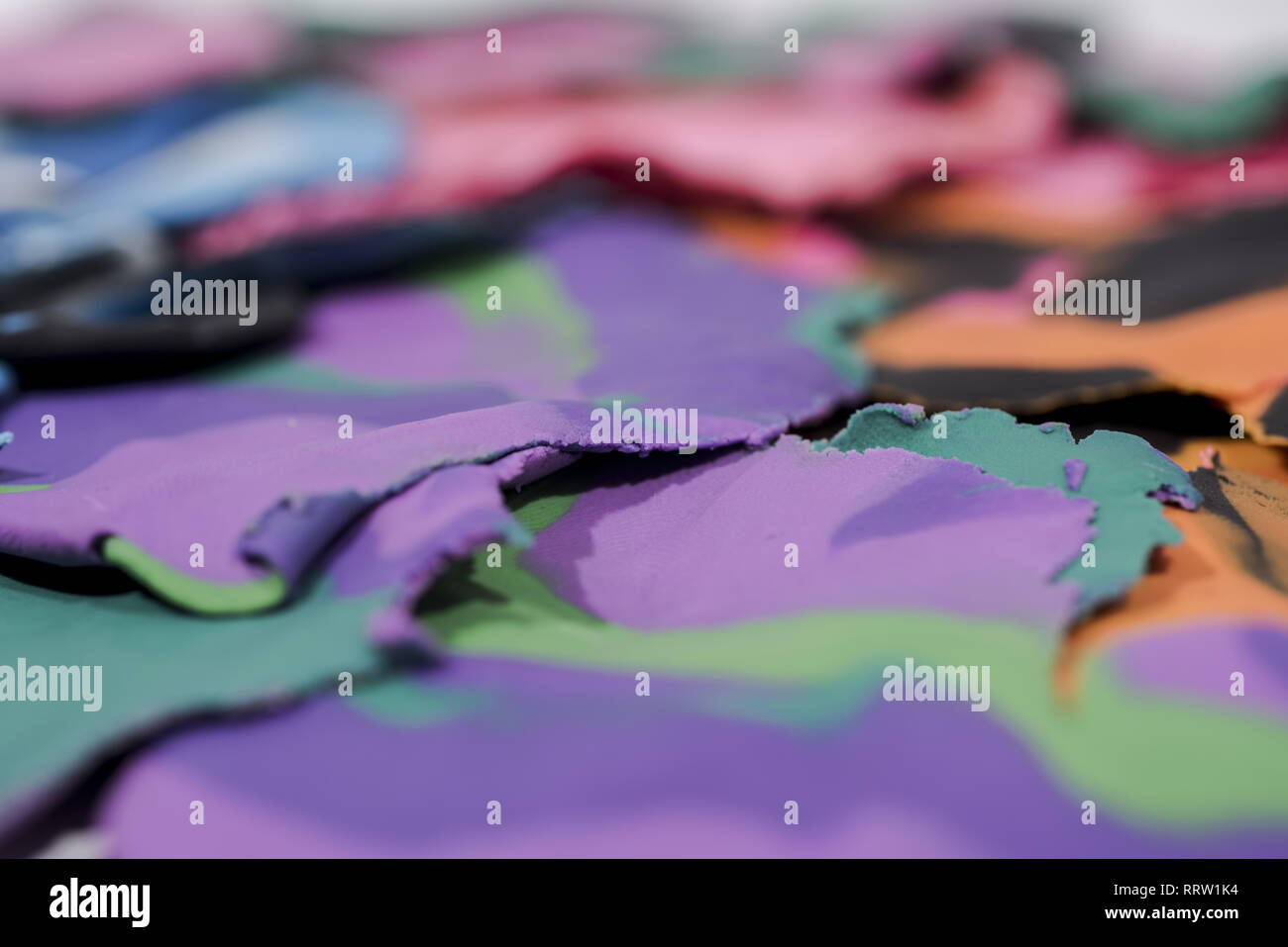 Red background with fingerprints made from plasticine. Stock Photo