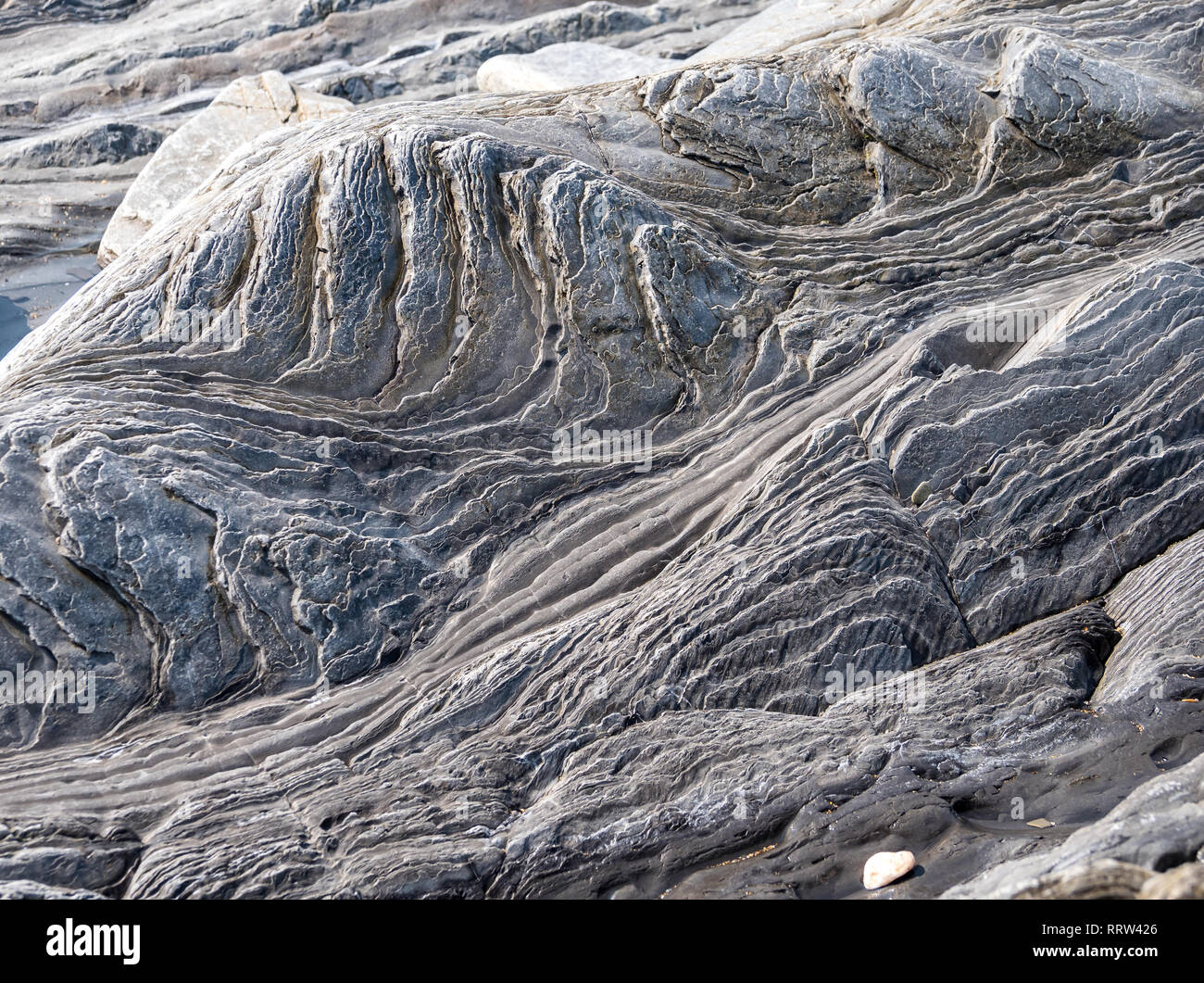 Flysch Coast of Sakoneta, Zumaia, Spain. Flysch is a sequence of sedimentary rock layers that progress from deep-water and turbidity flow deposits to  Stock Photo