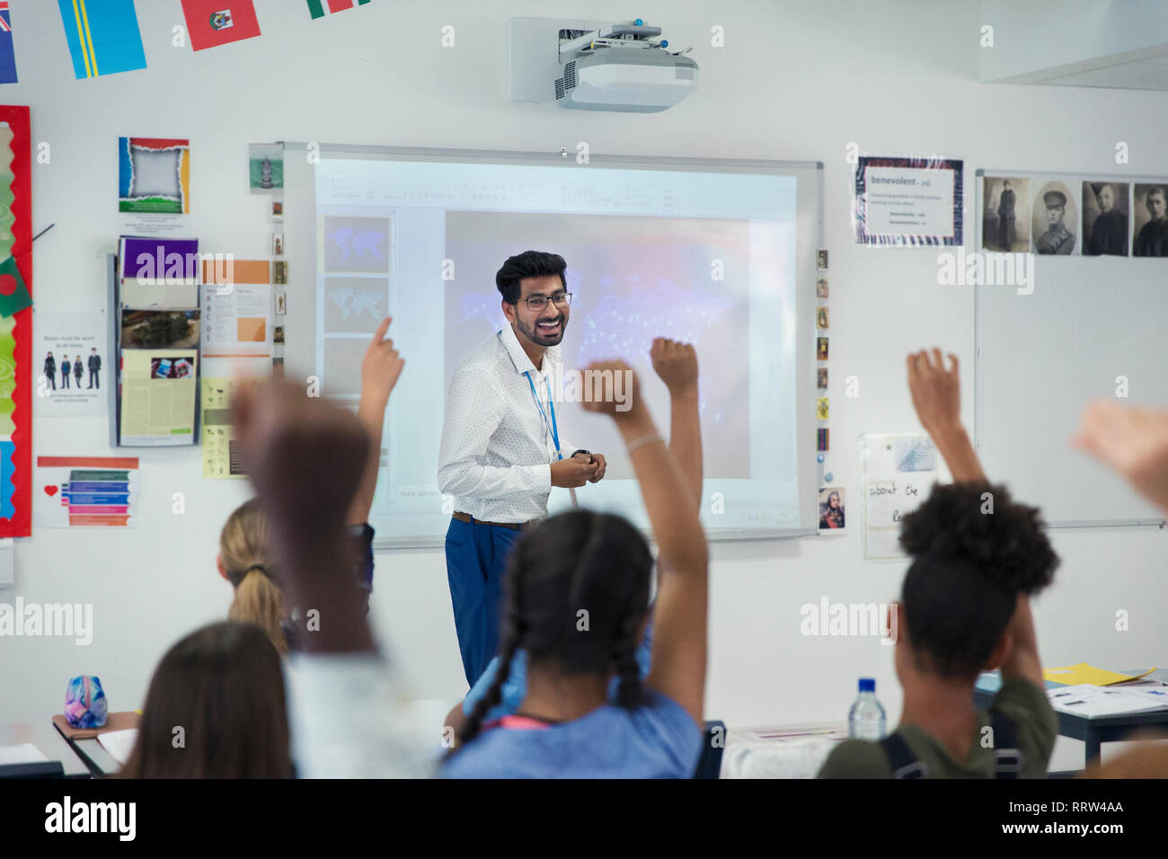 Smiling male teacher leading lesson in classroom Stock Photo