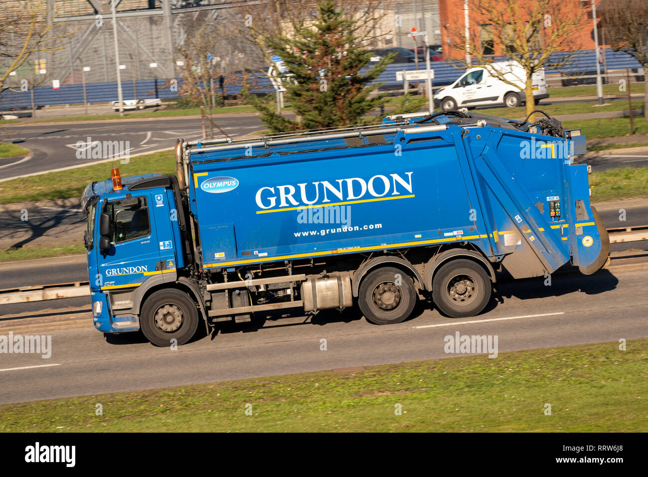 Grundon rubbish truck, Refuse lorry driving on the road. Grundon Waste Management Ltd blue Dennis Eagle with Olympus body vehicle bin lorry Stock Photo