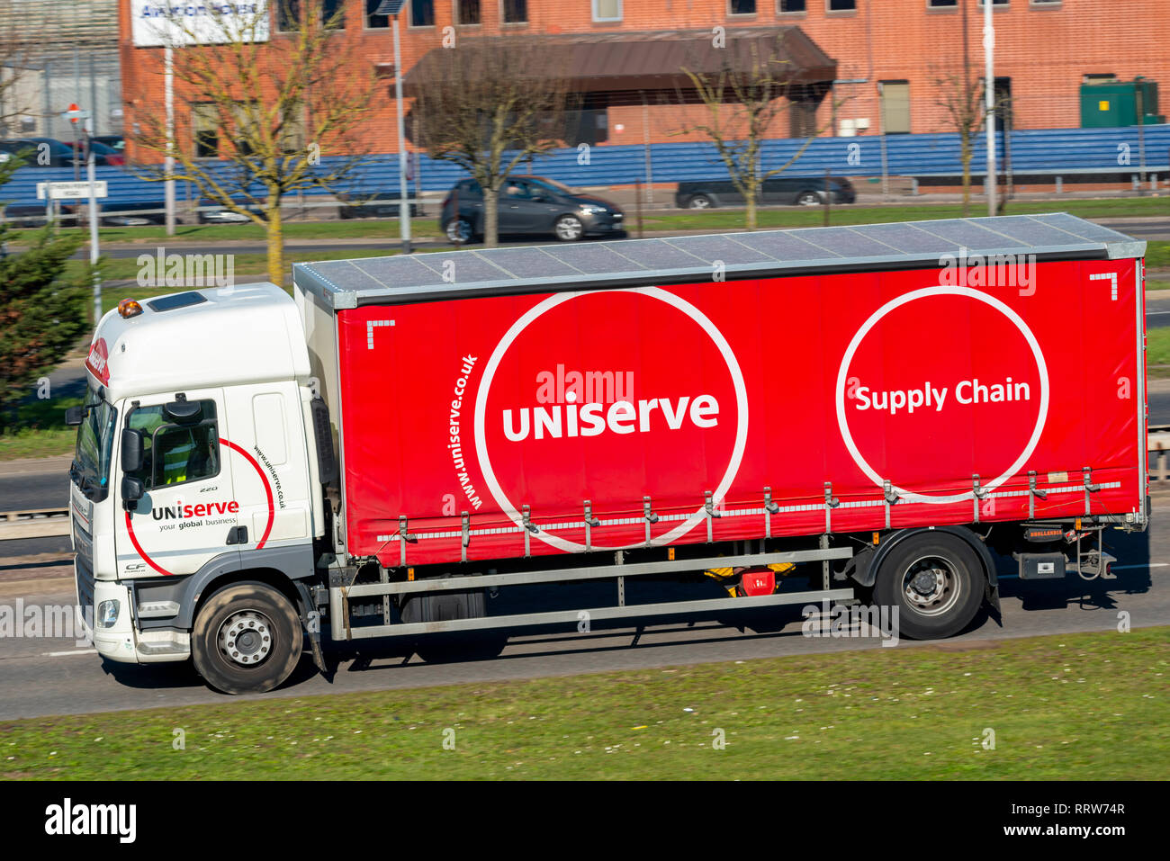 Uniserve supply chain curtain side vehicle. Lorry, truck. Uniserve Group logistics business commercial vehicle. DAF Tautliner, curtainsider with brand Stock Photo