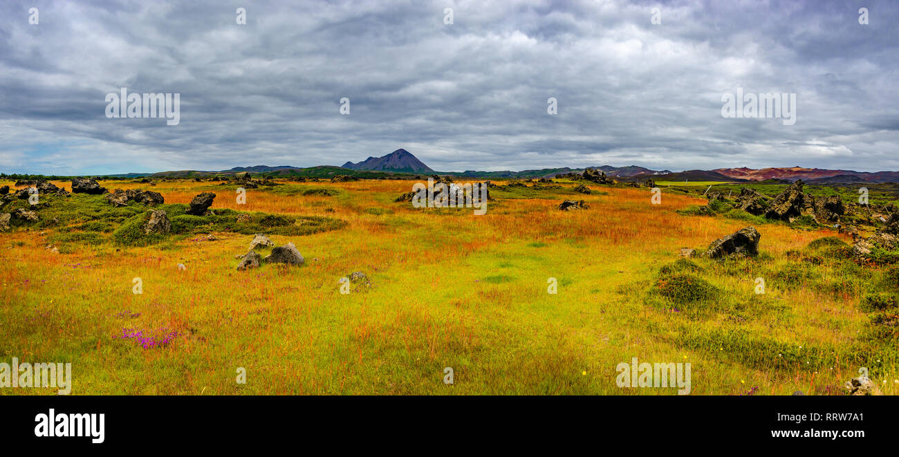 Panoramic view of lava field near lake Myvatn, town Reykjahlid, and volcanoes Hverfjall and Krafla on Iceland Stock Photo