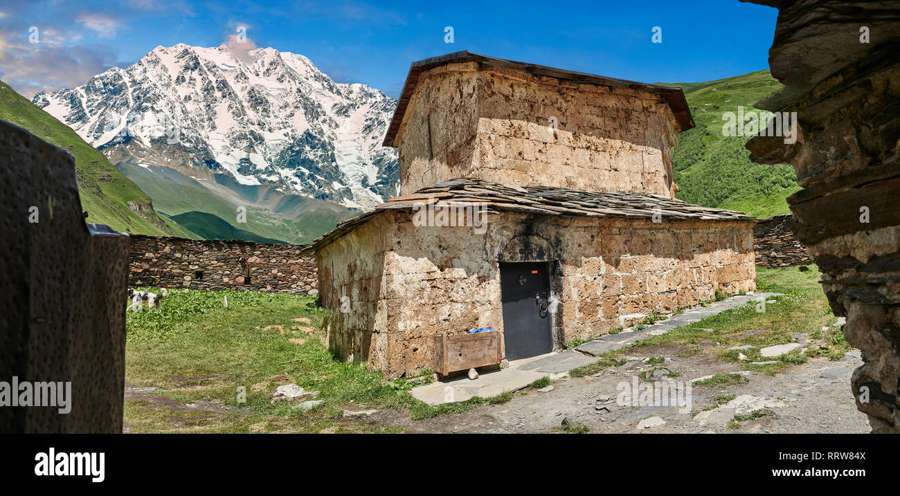 The medieval Georgian Orthodox St George Church “JGRag” with mount Shkhara (5193m) behind, Ushguli, Upper Svaneti, Samegrelo-Zemo Svaneti, Mestia, Geo Stock Photo