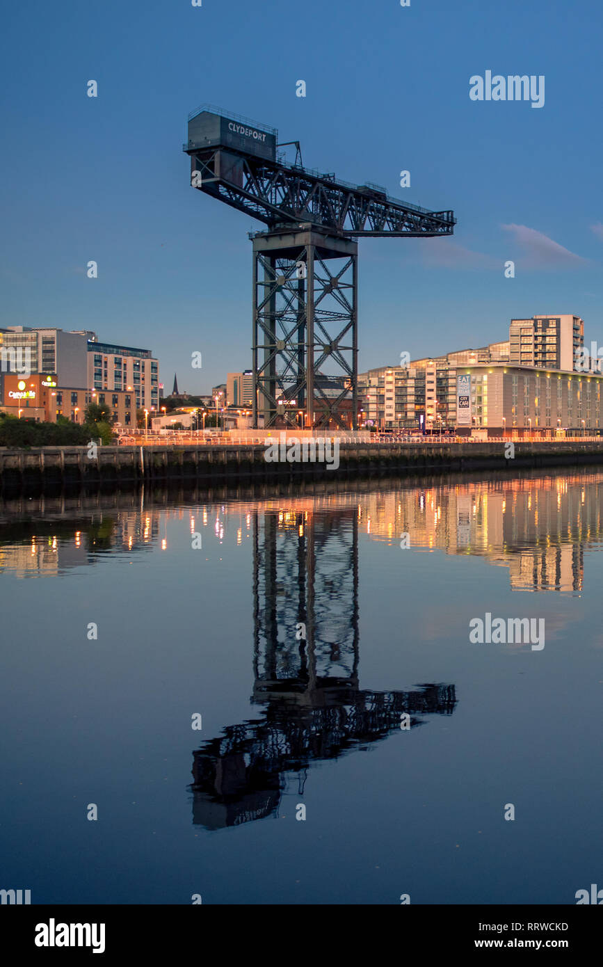 Glasgow/Scotland - September 20 2016: The Finnieston Crane against a blue sky, with a mirror image reflection in the Clyde River Stock Photo