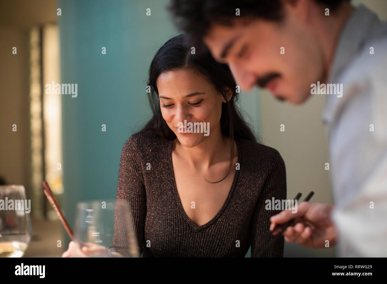 Couple eating dinner with chopsticks Stock Photo