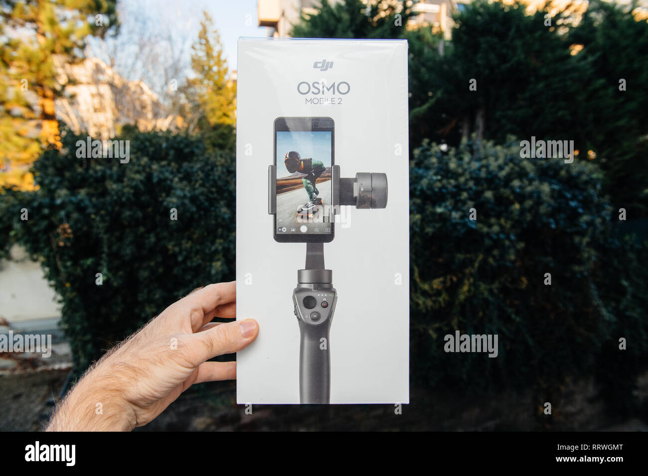 PARIS, FRANCE - NOV 22, 2018: Man hand holding in outdoor background new DJI Osmo Mobile 2 Smartphone Gimbal manufactured by the SZ DJI Technology Co., Ltd company horizontal Stock Photo