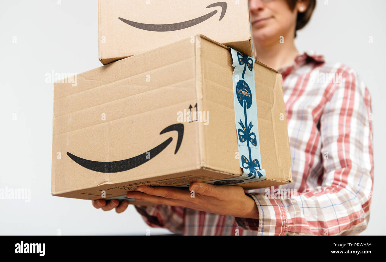 PARIS, FRANCE - DEC 2, 2018: Amazon Prime parcel cardboard box stack one above another ready for winter holidays gifts shopping in woman hand Stock Photo