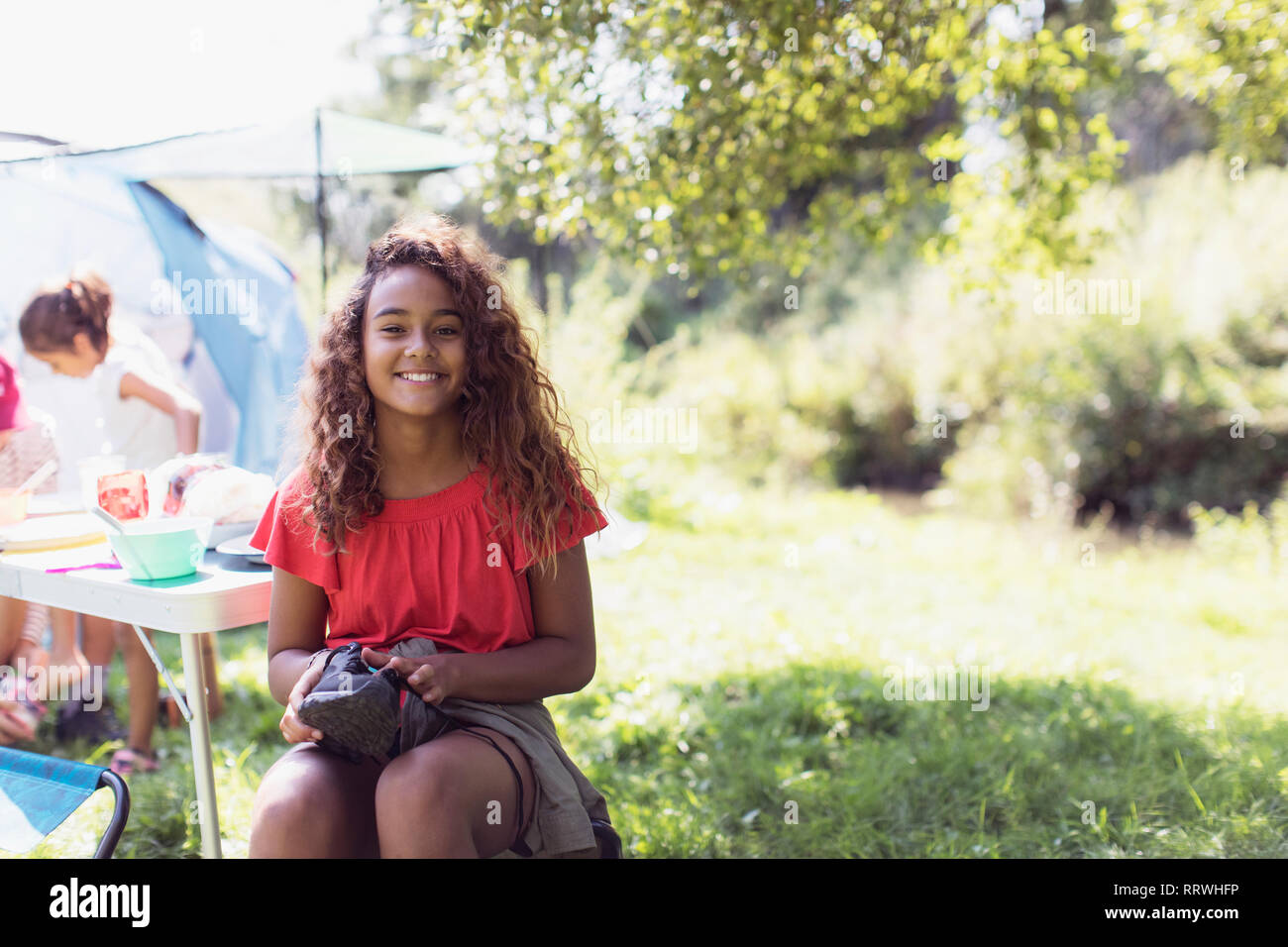 Portrait happy girl at campsite Stock Photo