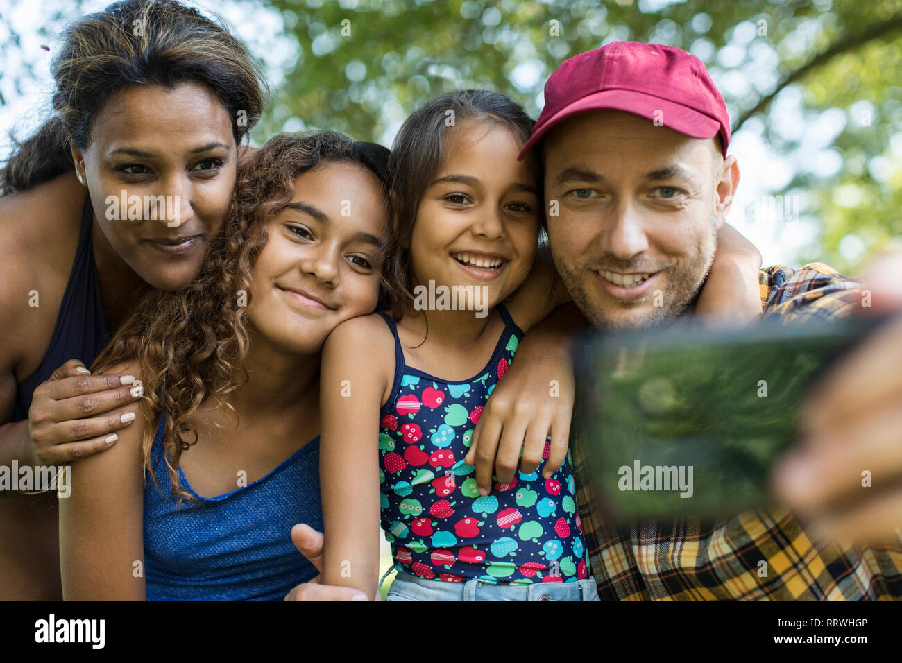 Happy family taking selfie with camera phone Stock Photo