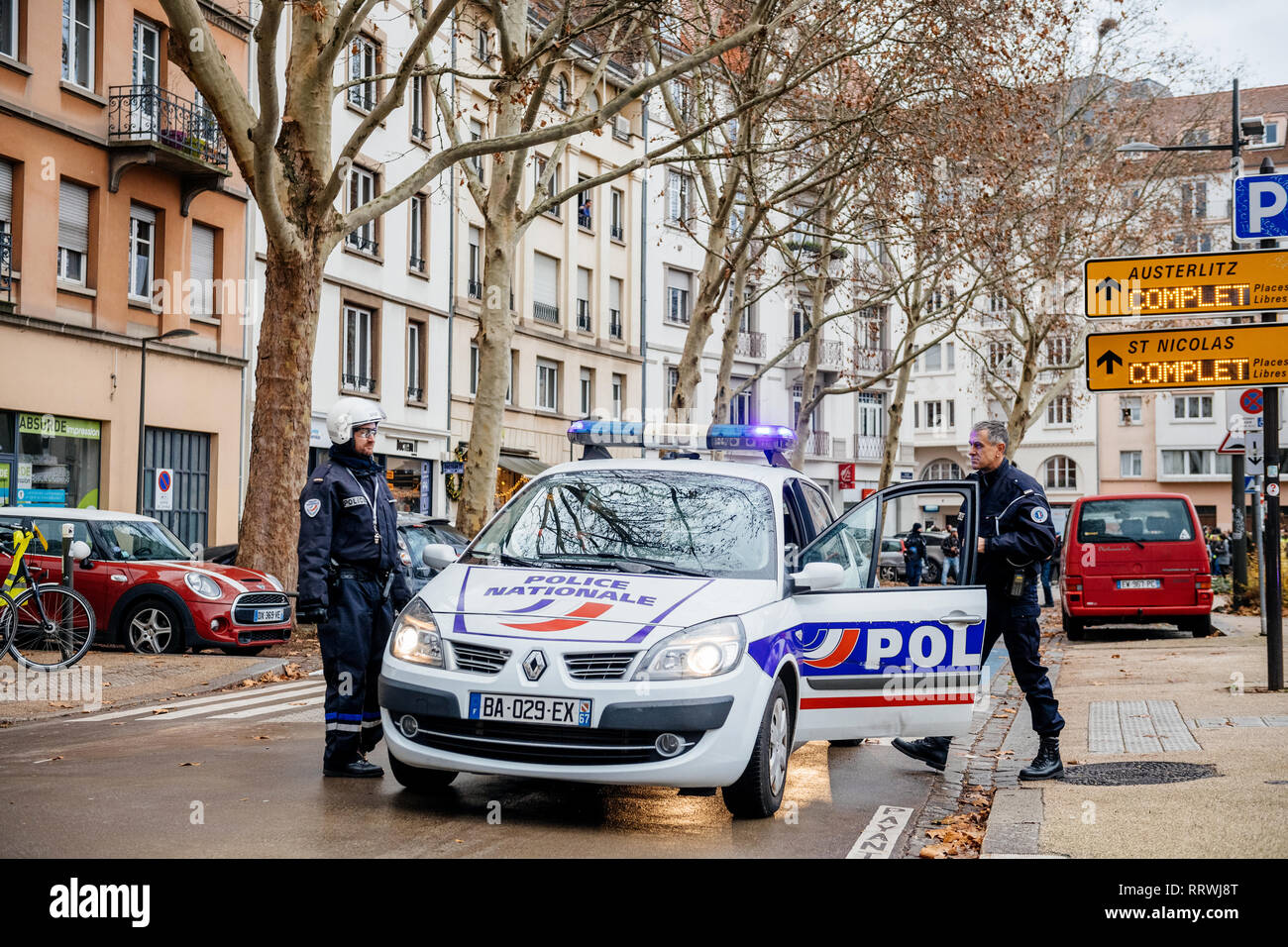 STRASBOURG, FRANCE - DEC 8, 2018: Police officer securing the zone in front of crowd marching in Central Strasbourg at the nationwide protest demonstration Marche Pour Le Climat Stock Photo
