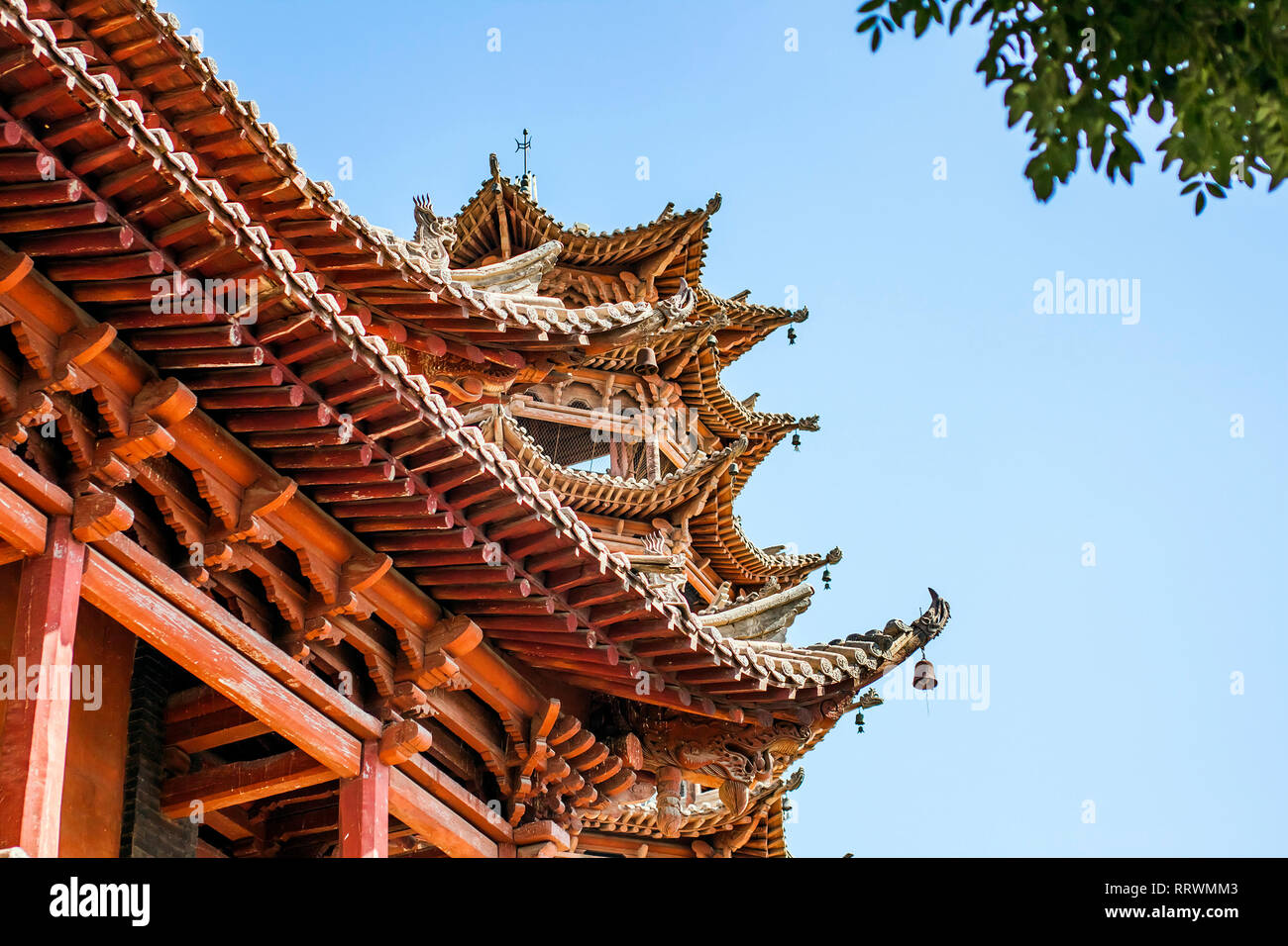 Wooden Traditional Chinese Roof Of Pagoda On Sunny Day. Old Roof Structure Of Buddhist Temple And Blue Sky. Oriental Architecture Of Asian Monastery Stock Photo