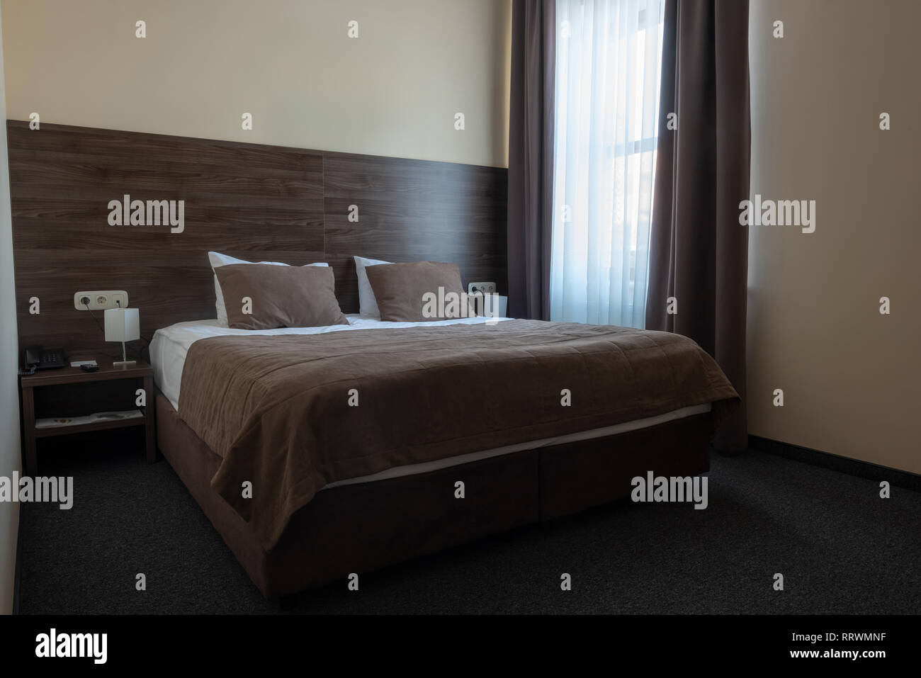 hotel room interior with window and comfortable bed Stock Photo