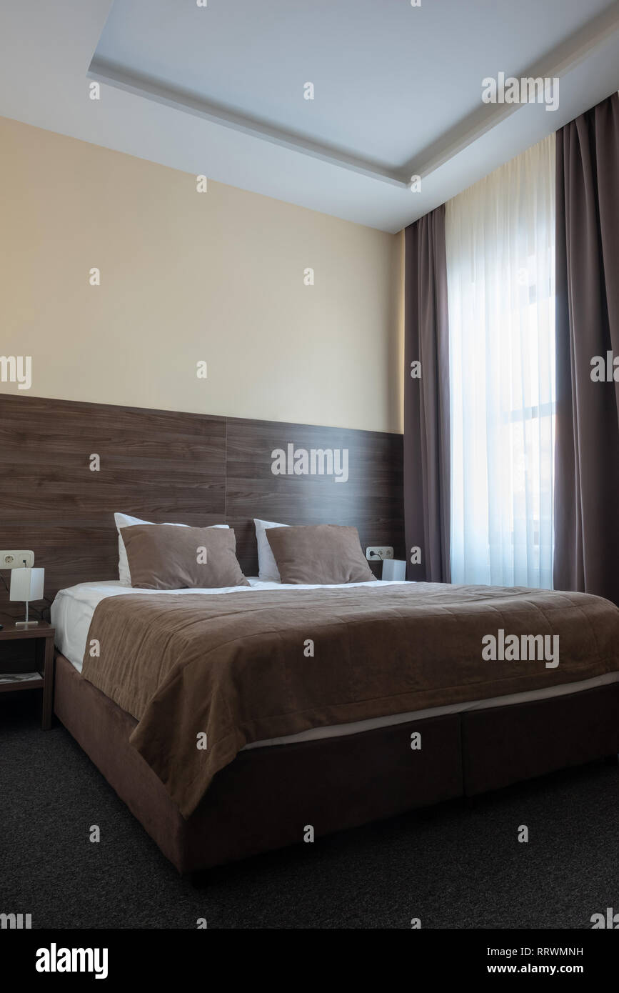 hotel room interior with bed in brown color Stock Photo