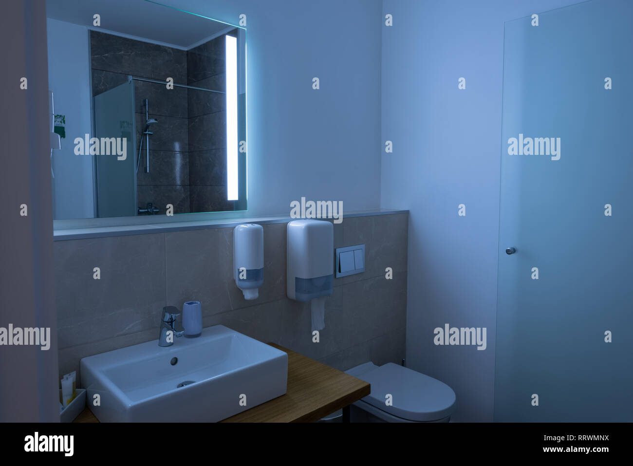 bathroom interior with sink, toilet, and mirror Stock Photo