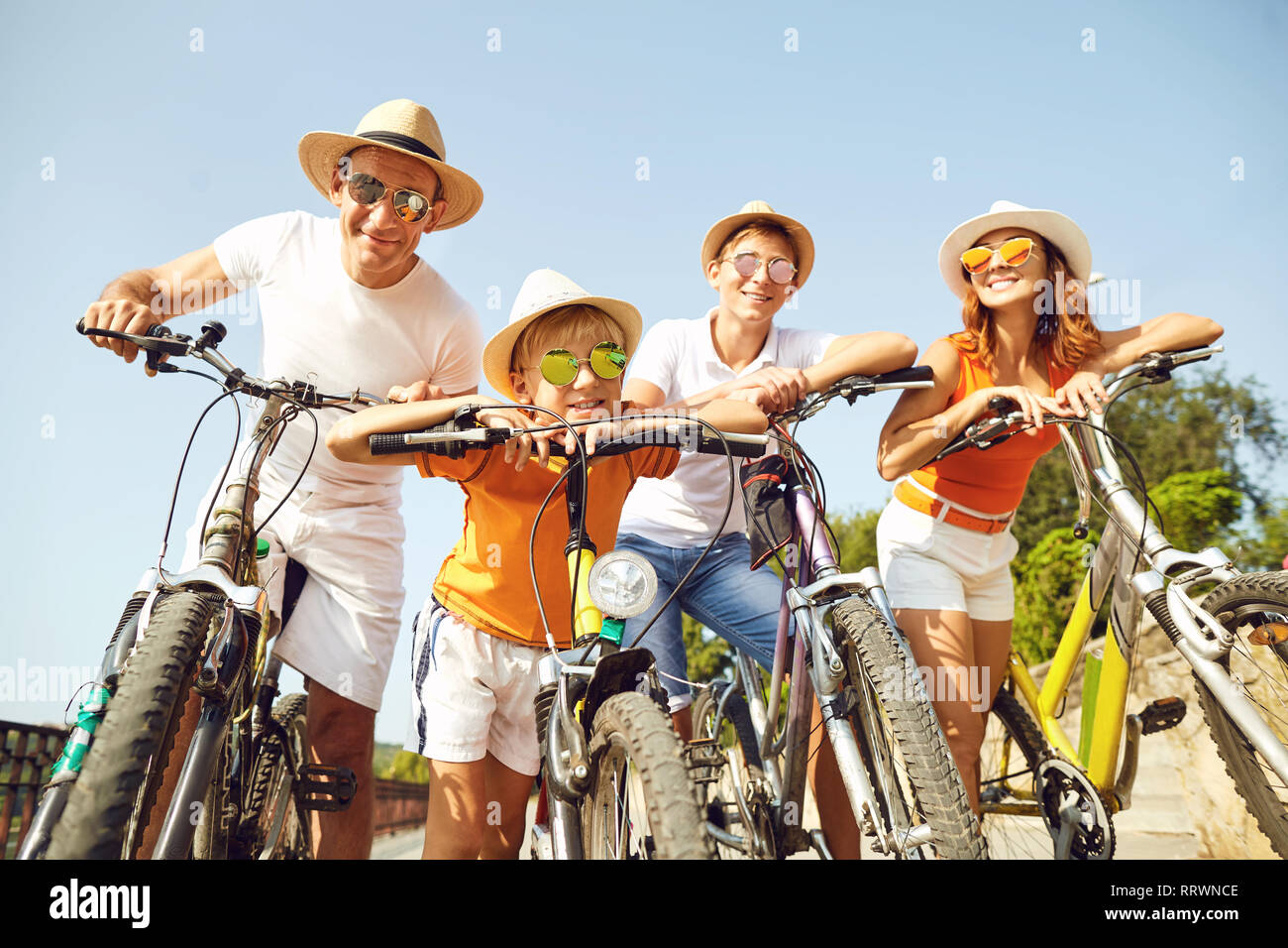 Happy family on bicycles for a walk in park. Stock Photo